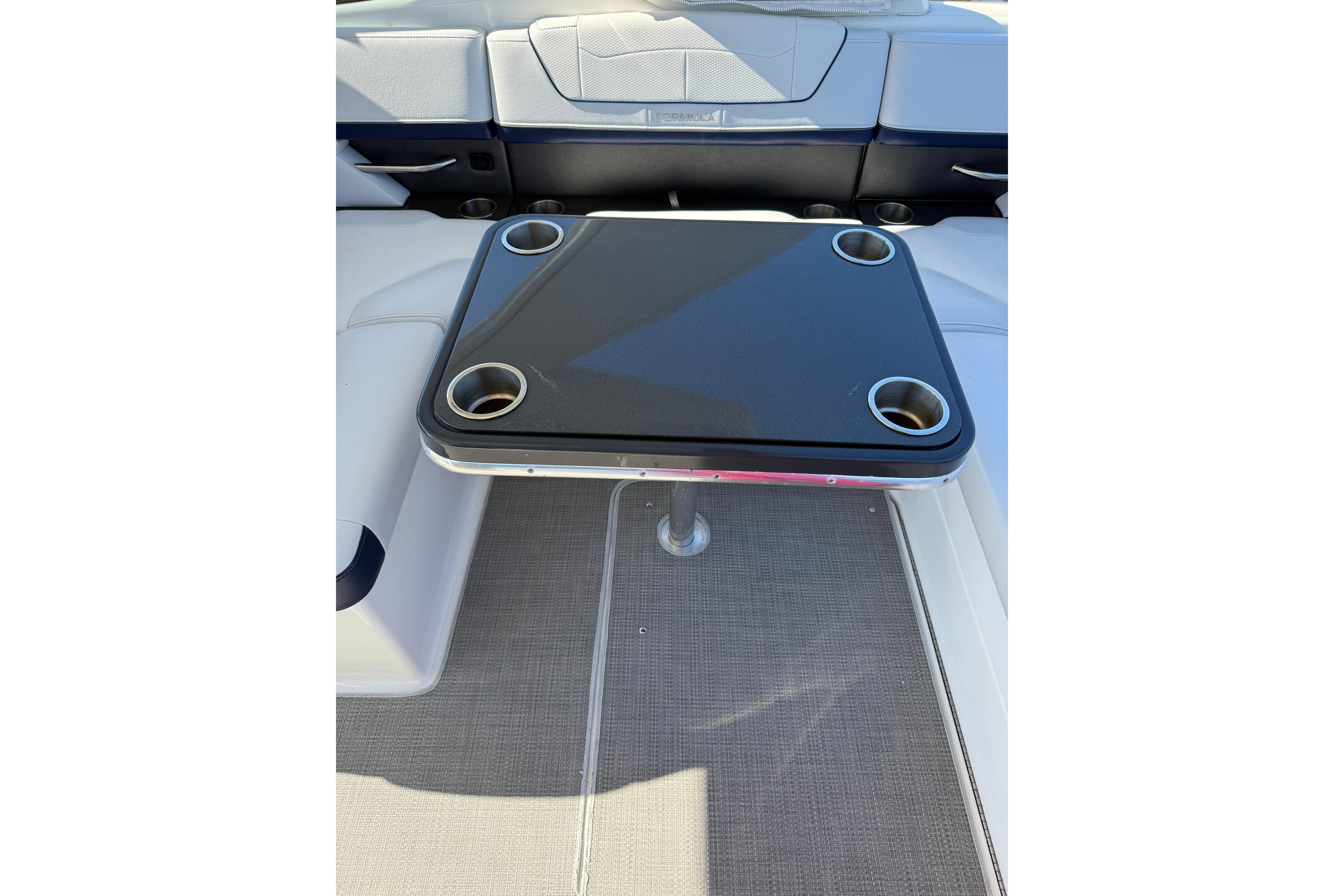 2022 Formula 350 Crossover Bowrider OB interior with table and cup holders.
