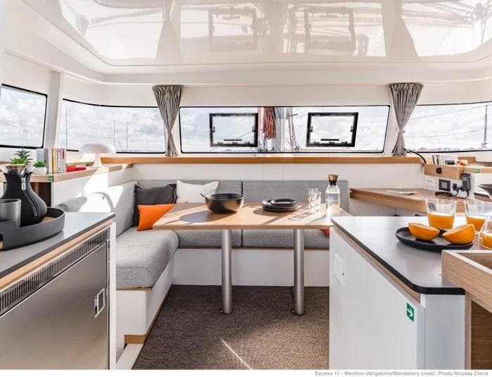 Manufacturer Provided Image: Modern interior of 2026 Excess 11 catamaran with dining area and kitchen.