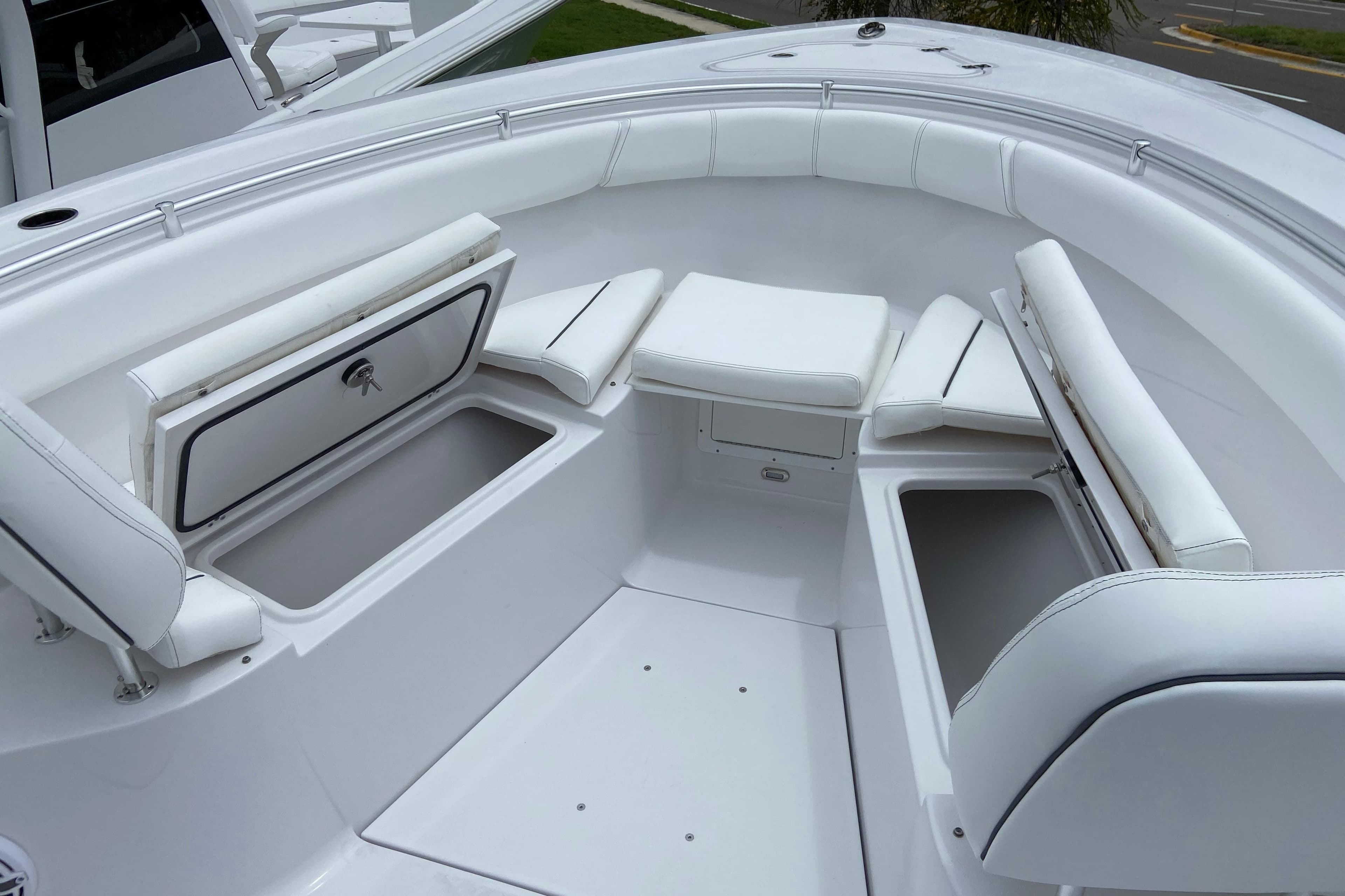 2026 Sportsman Open 302 Center Console boat with white seating and storage compartments.