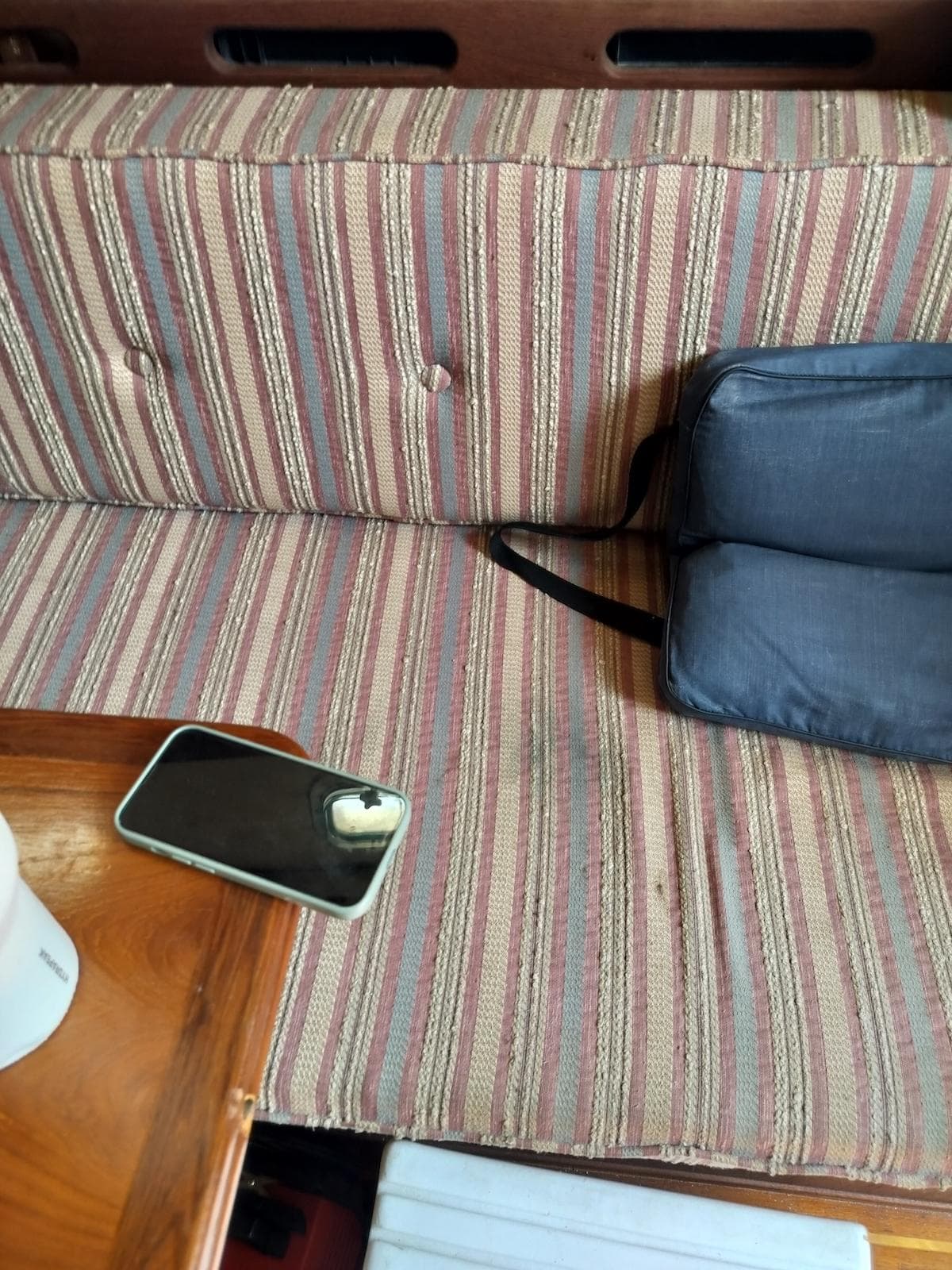 Striped boat seat with a phone and bag, Morgan 32-3, 1983.