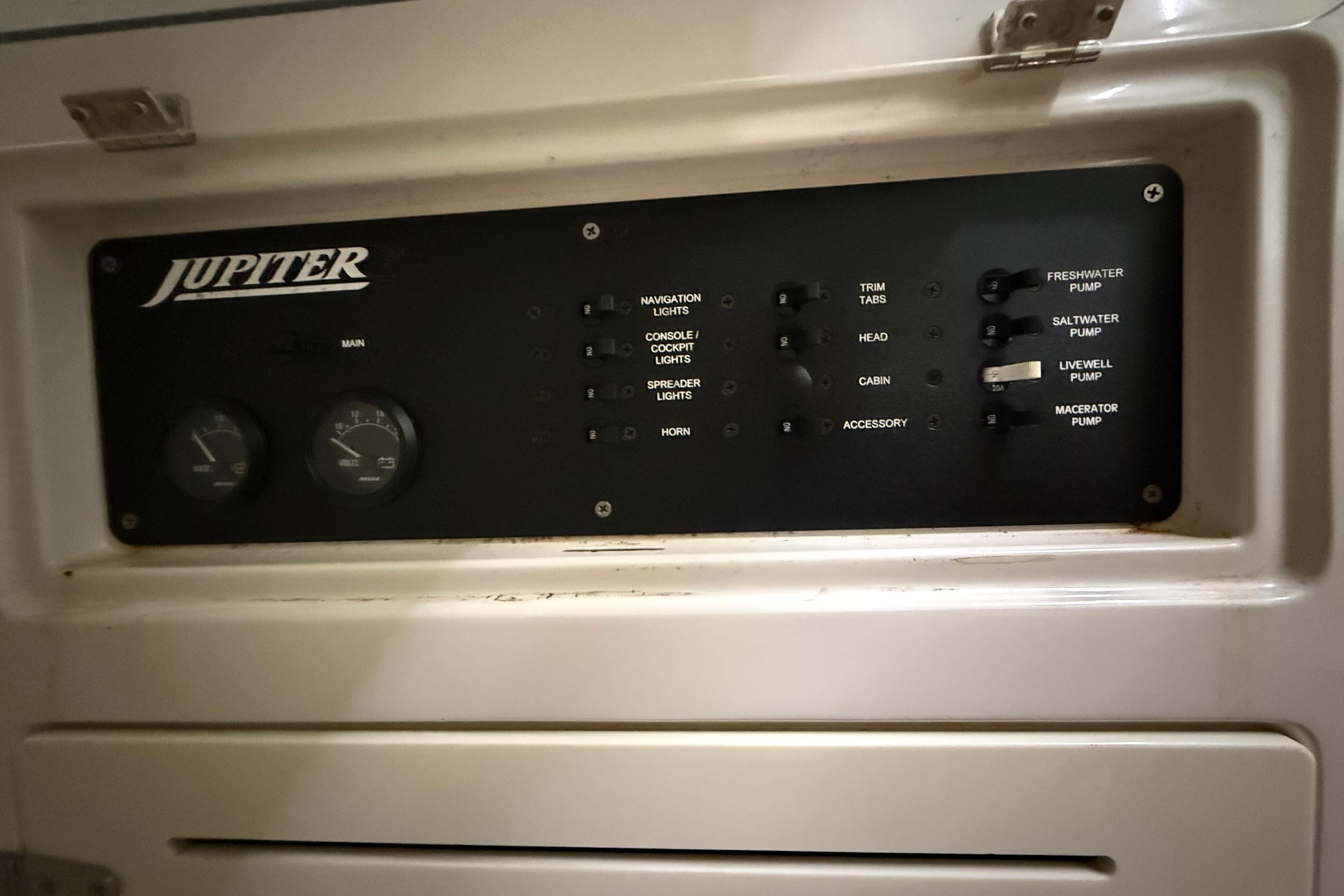Control panel of a 2008 Jupiter 34 FS boat with various switches and gauges.