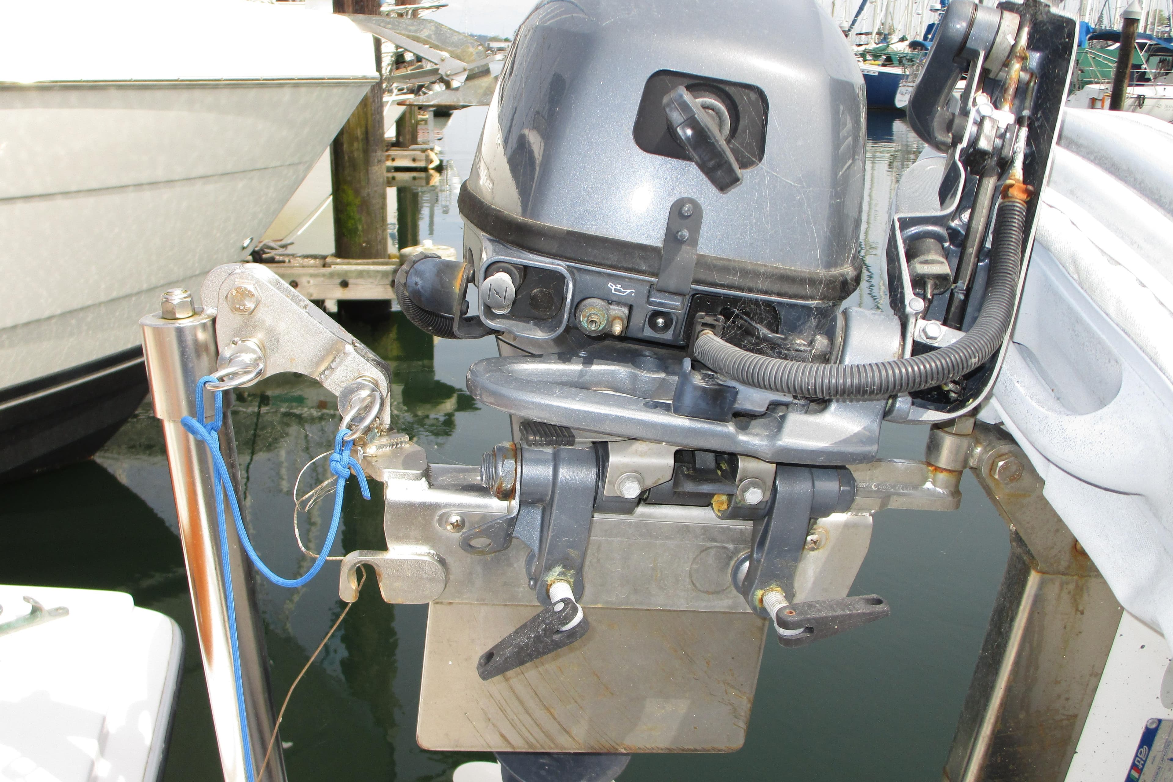Outboard motor mounted on a 1972 Uniflite 36 Sport Sedan boat at a marina.