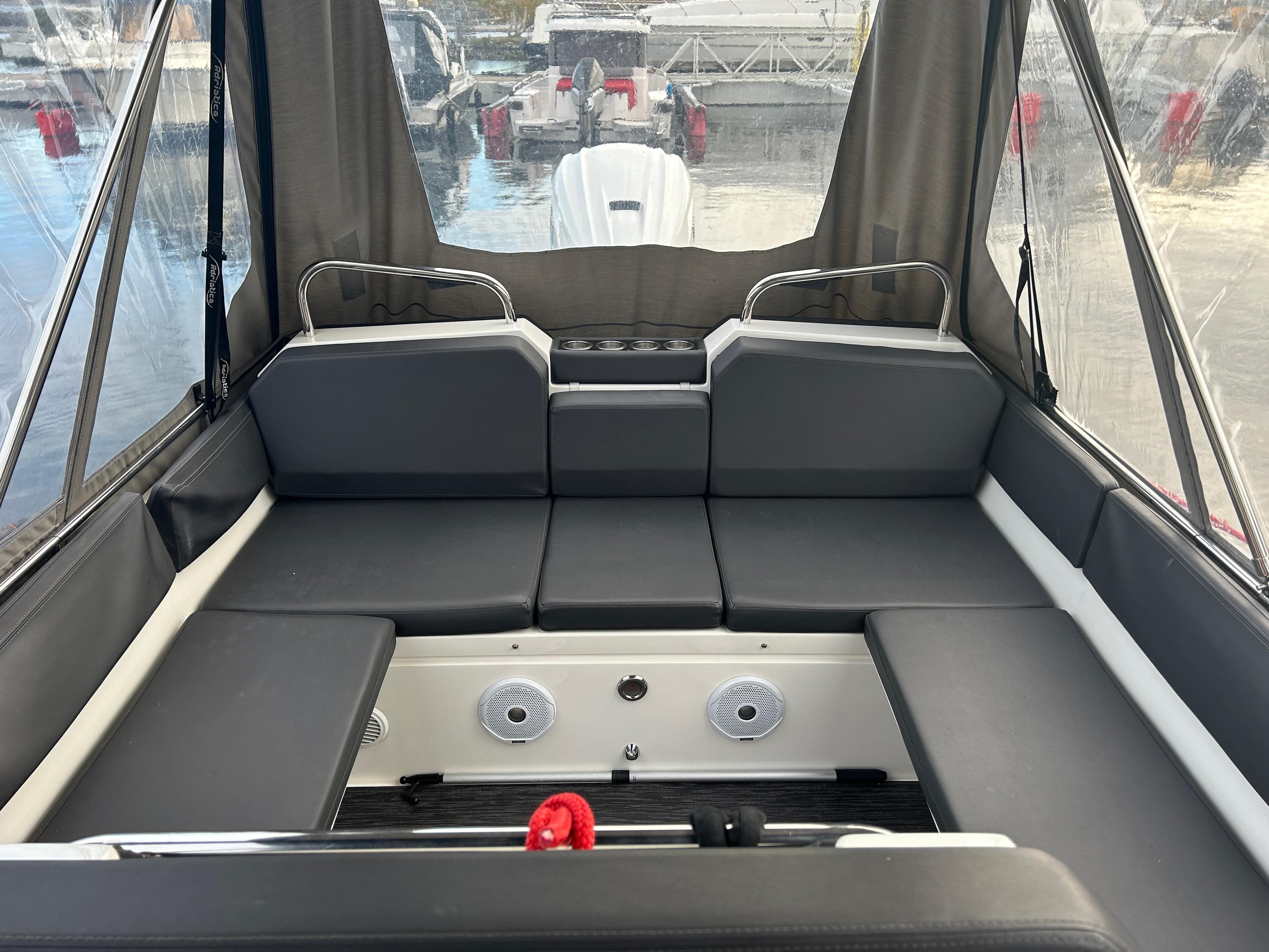 Interior of 2018 Agapi 950 boat with cushioned seating and clear canopy.