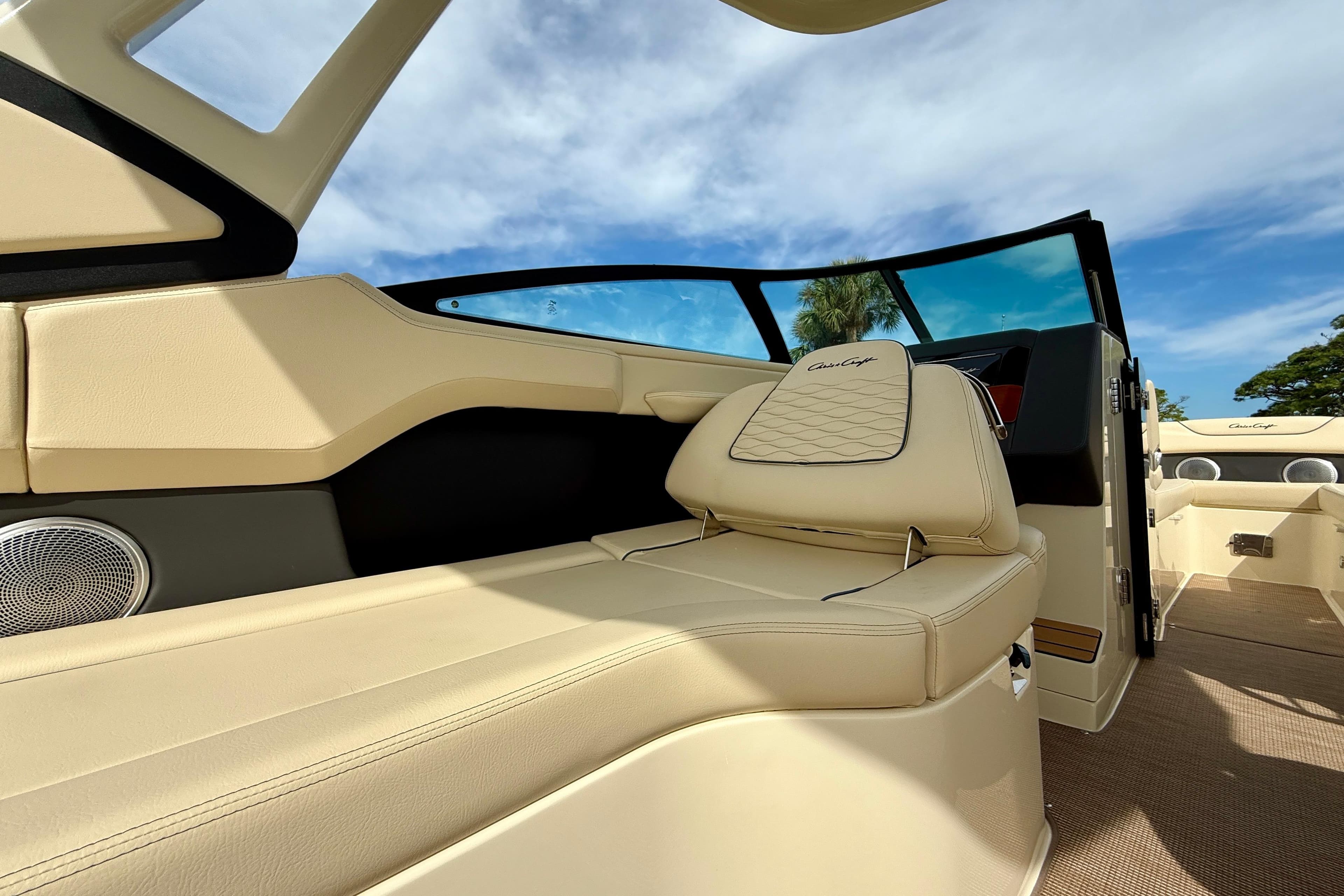 Luxurious interior of 2026 Chris-Craft Sportster 28 boat with beige seating and modern design.