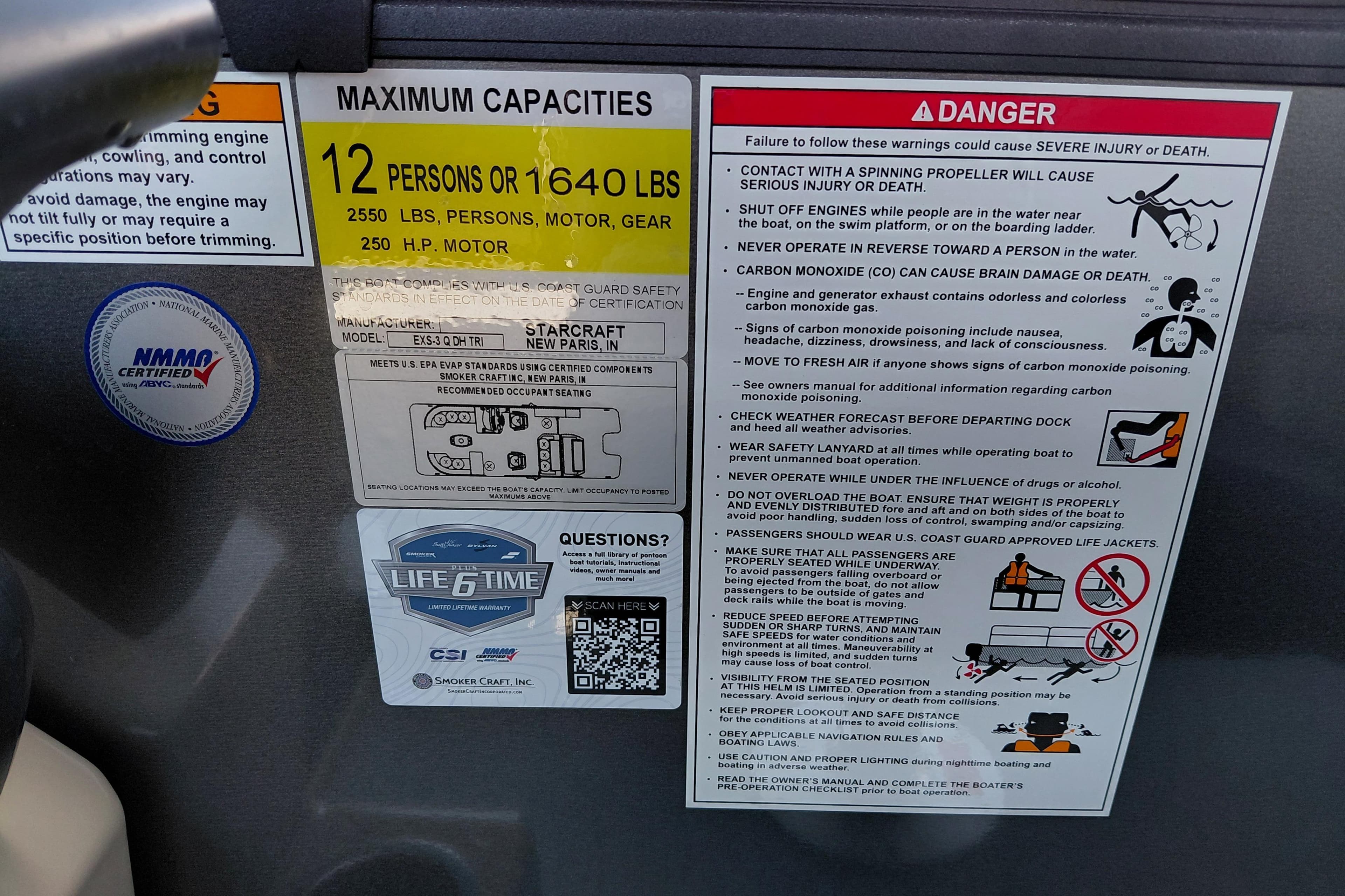 Warning and capacity labels on a 2026 Starcraft EXS 3 Q DH boat.