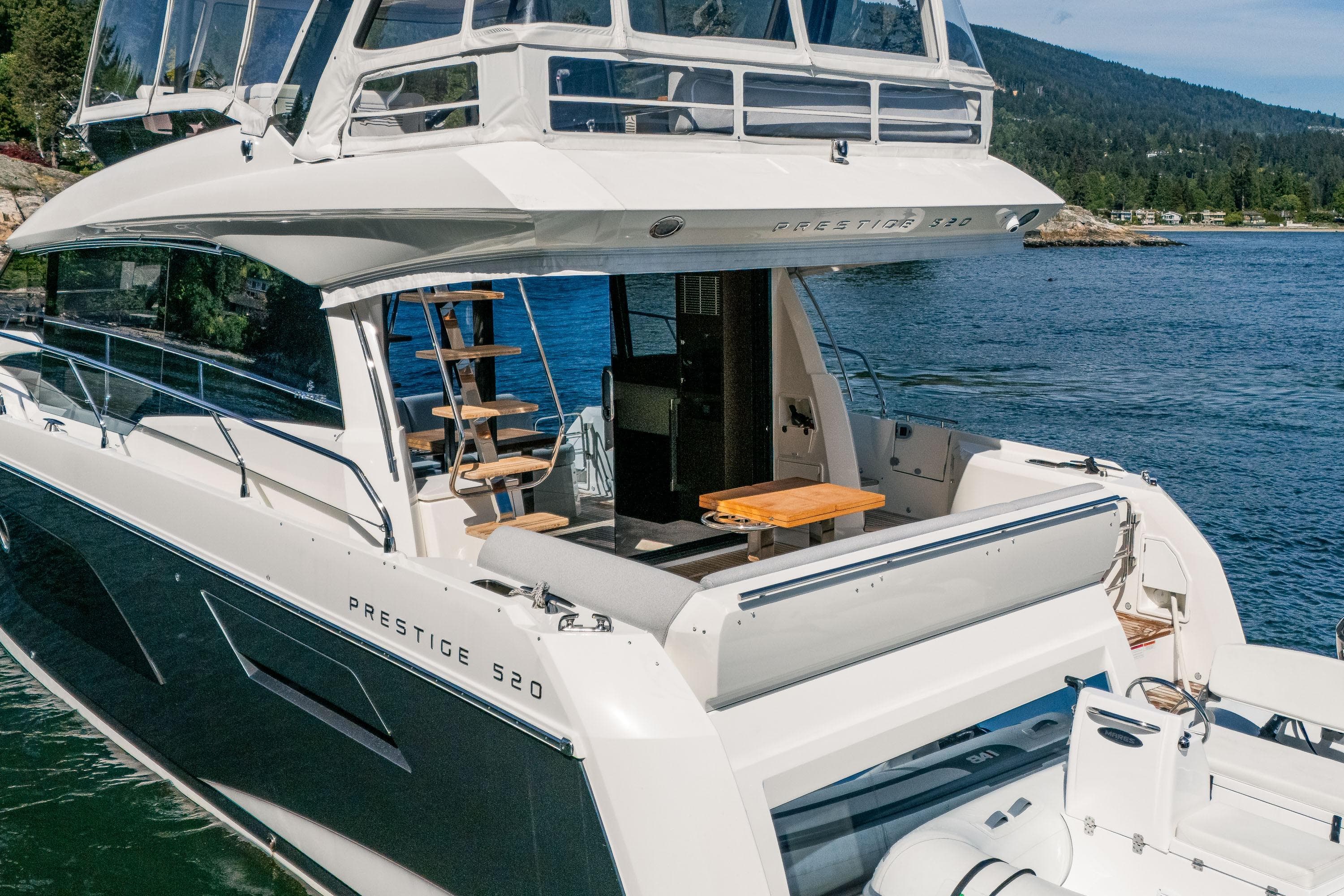 Luxury 2022 Prestige 520 yacht on serene water, showcasing elegant design and spacious deck.