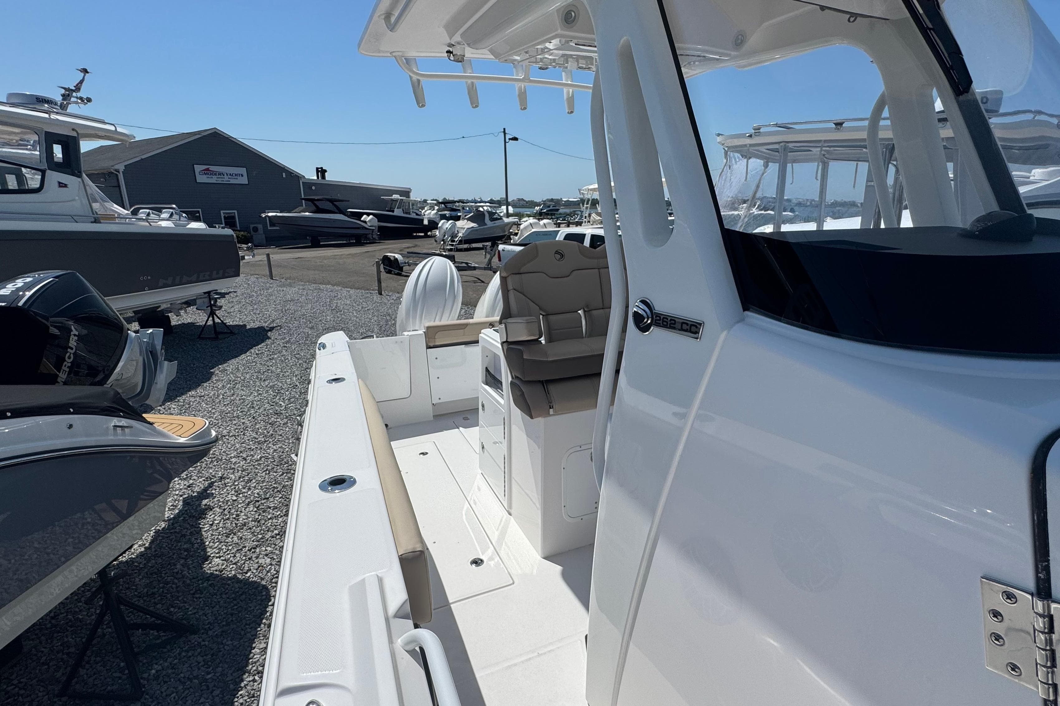 2026 Edgewater 262CC boat at a marina, showcasing sleek design and spacious deck.