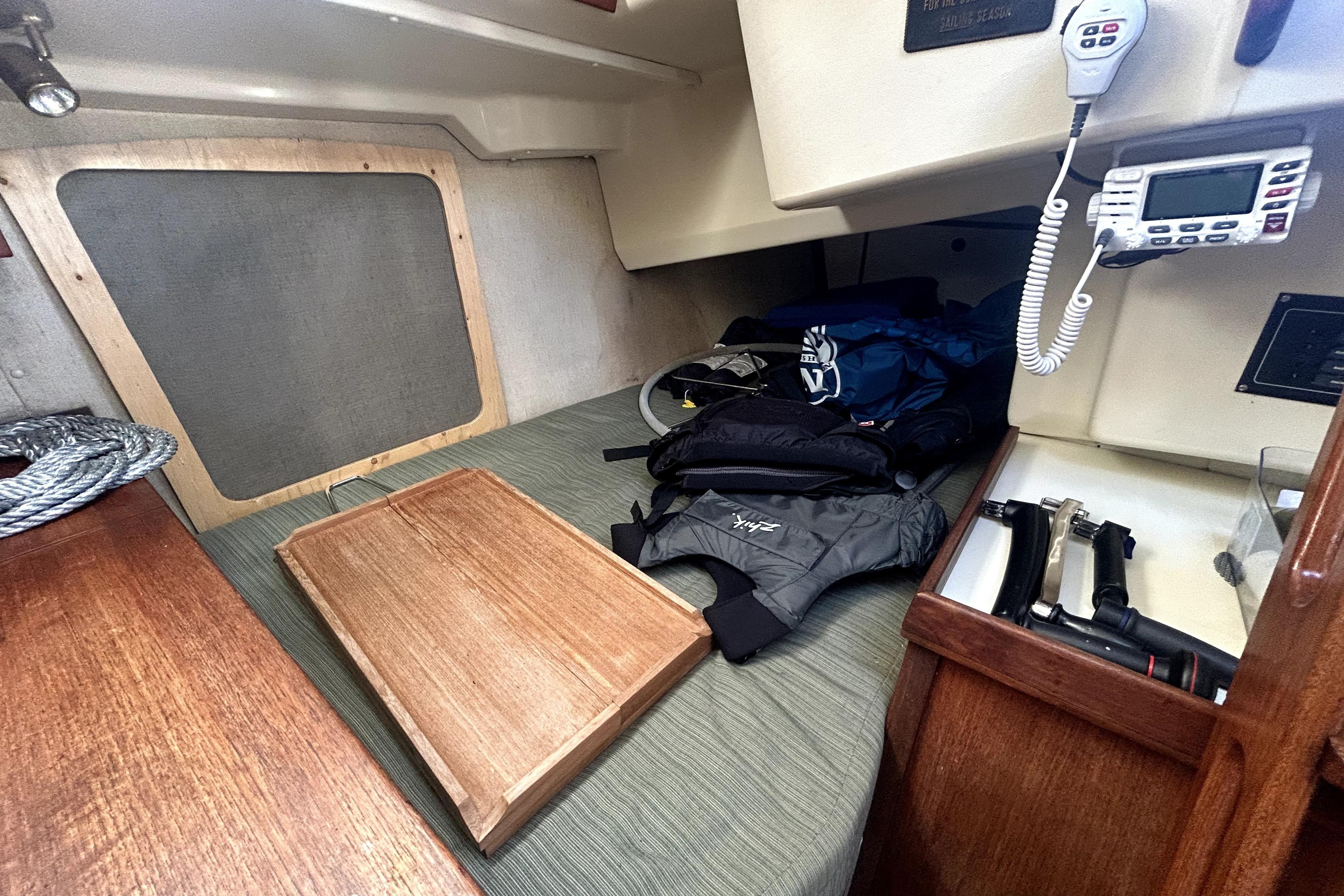 Interior of 1983 Pearson 34 sailboat with navigation equipment and gear storage.