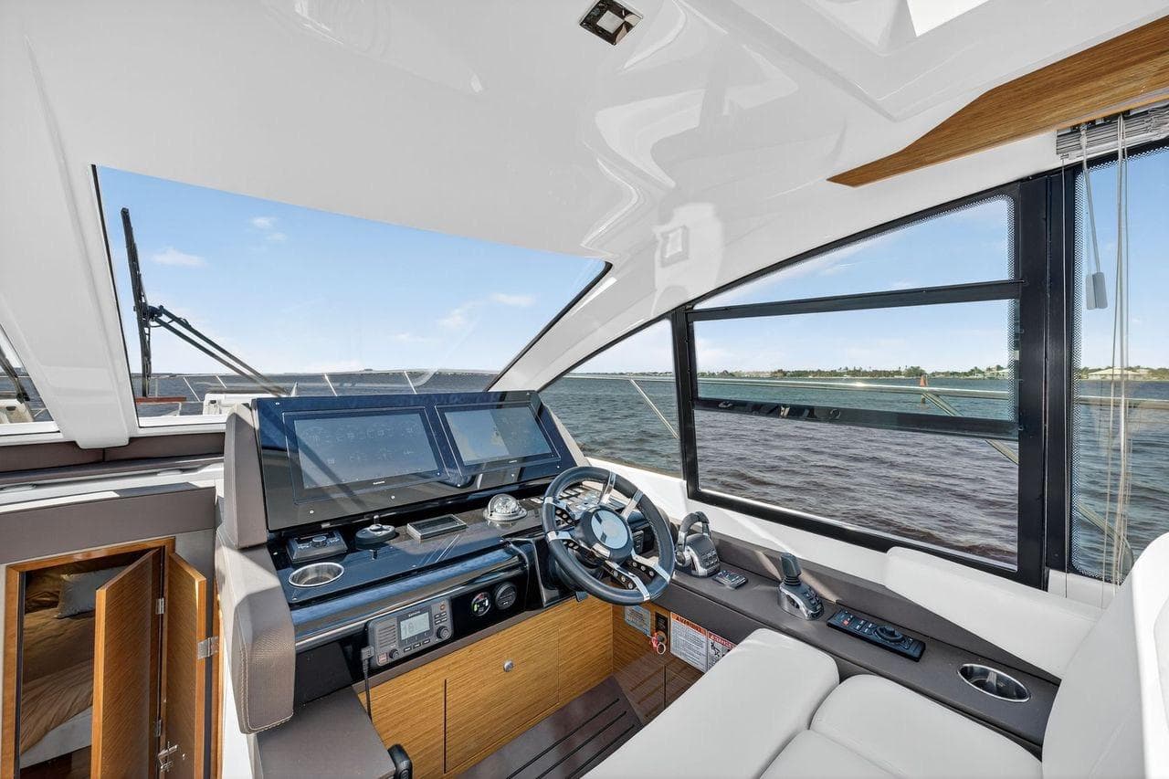 2020 Cruisers Yachts 50 Cantius helm with modern controls and panoramic water view.