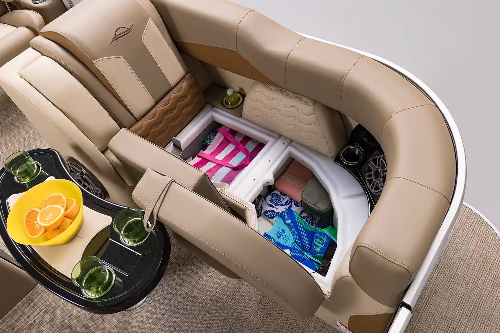 Luxurious seating and storage on 2026 SunCatcher Elite 322SR boat, featuring refreshments and accessories.