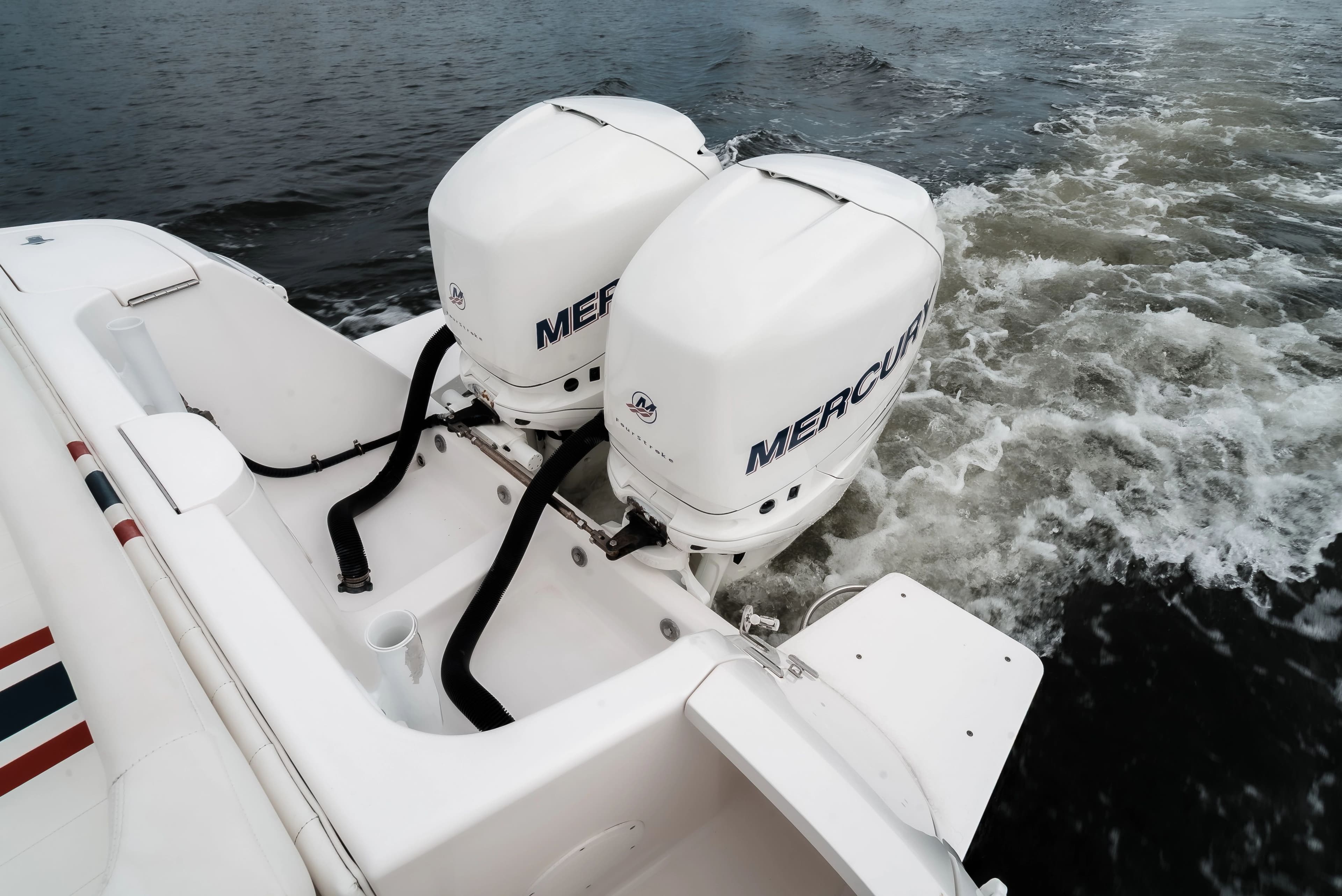 Intrepid 327CC boat with Mercury outboard engines on water.
