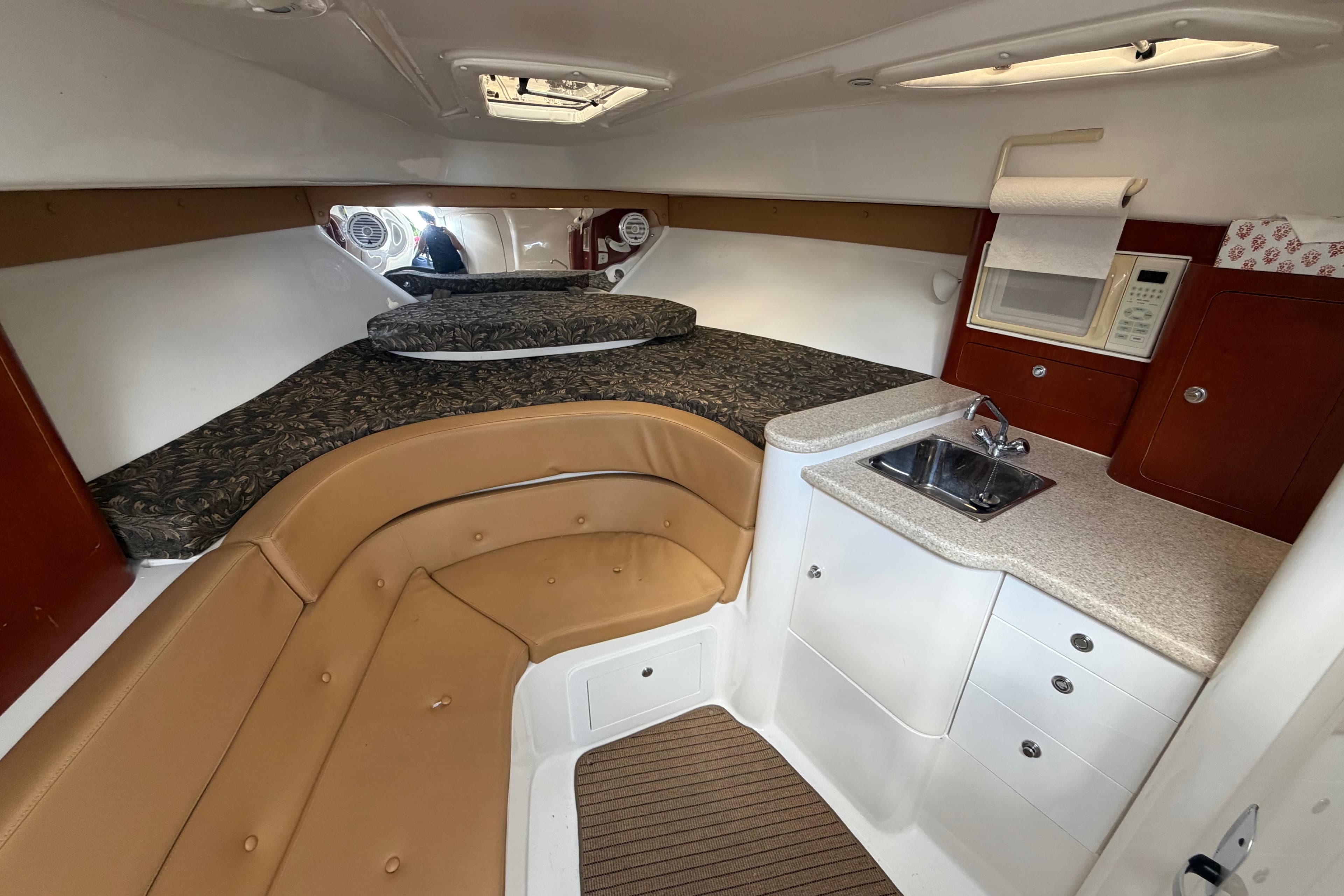 Interior of 2008 Intrepid 350 Center Console with bed, kitchenette, and seating area.