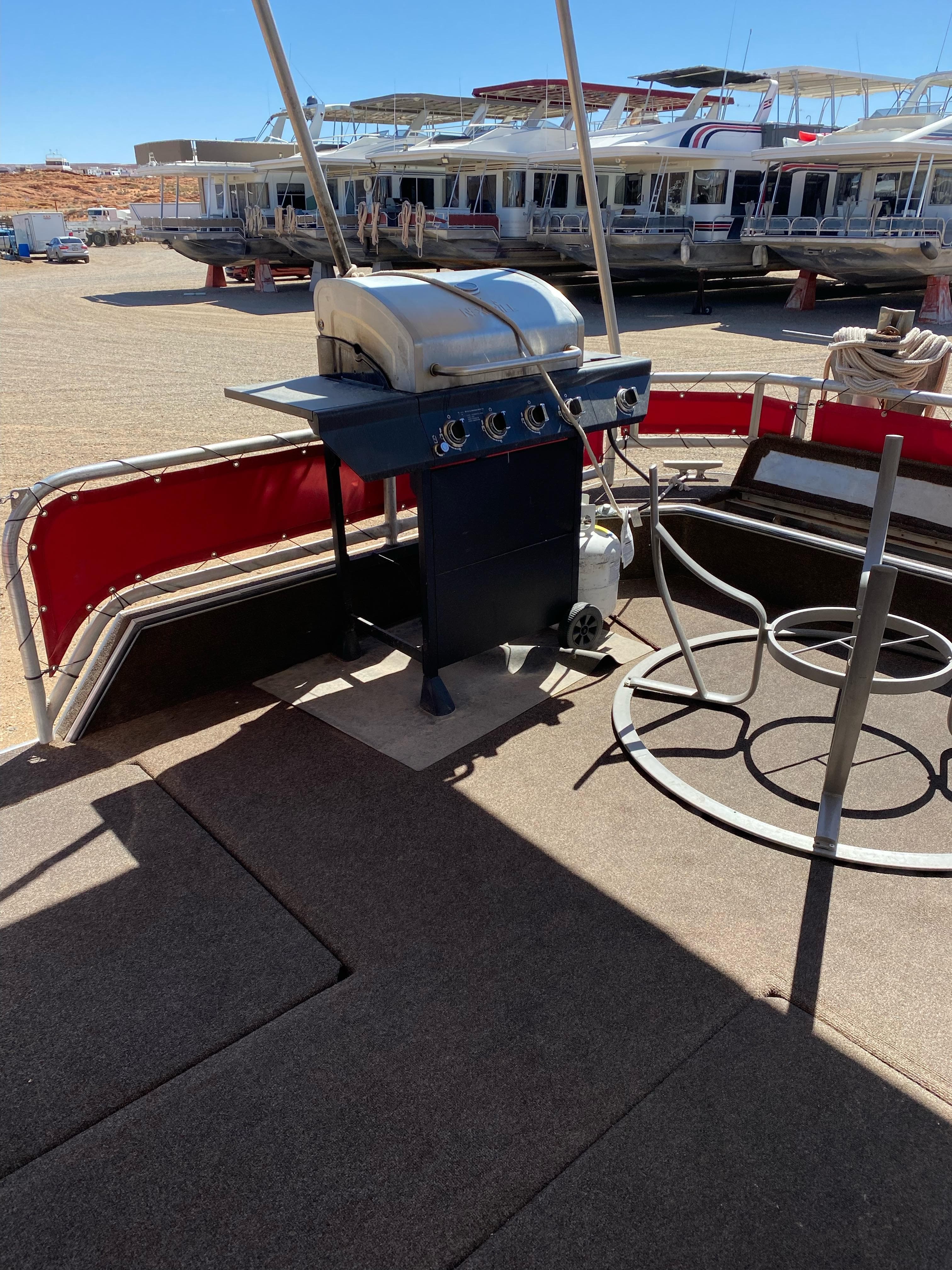 Outdoor deck with a grill on a 2003 Stardust Cruisers Red Rock Retreat Week 26 houseboat.