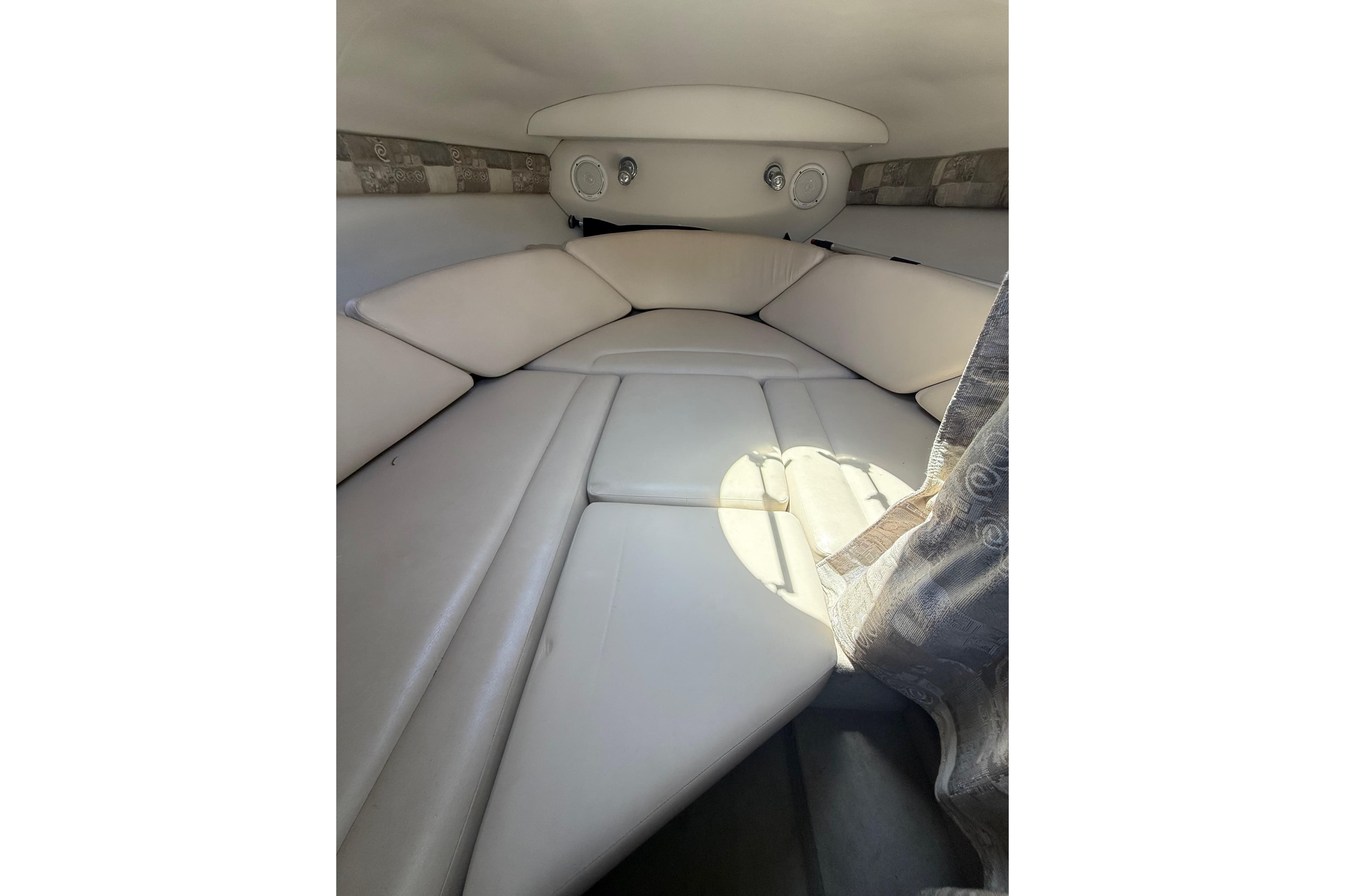 Interior cabin of 2011 Crownline 236 SC boat with cushioned seating.
