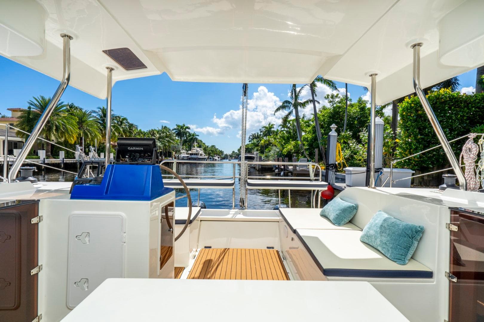 Luxurious interior of 2025 Smart Cat E280 Electric boat with canal view and plush seating.