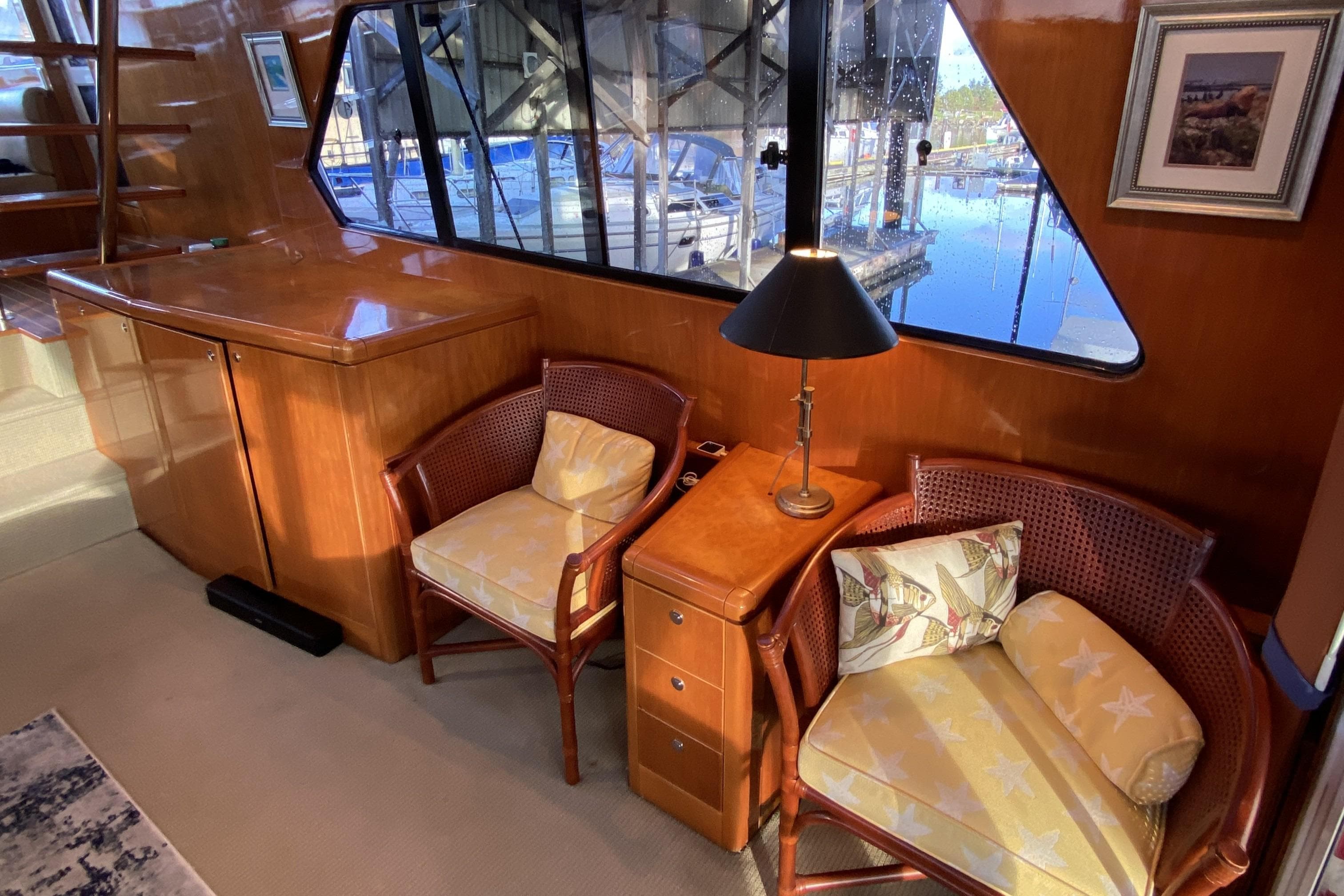 Interior of a 2000 Compass 55 yacht with cozy seating and elegant wood finish.