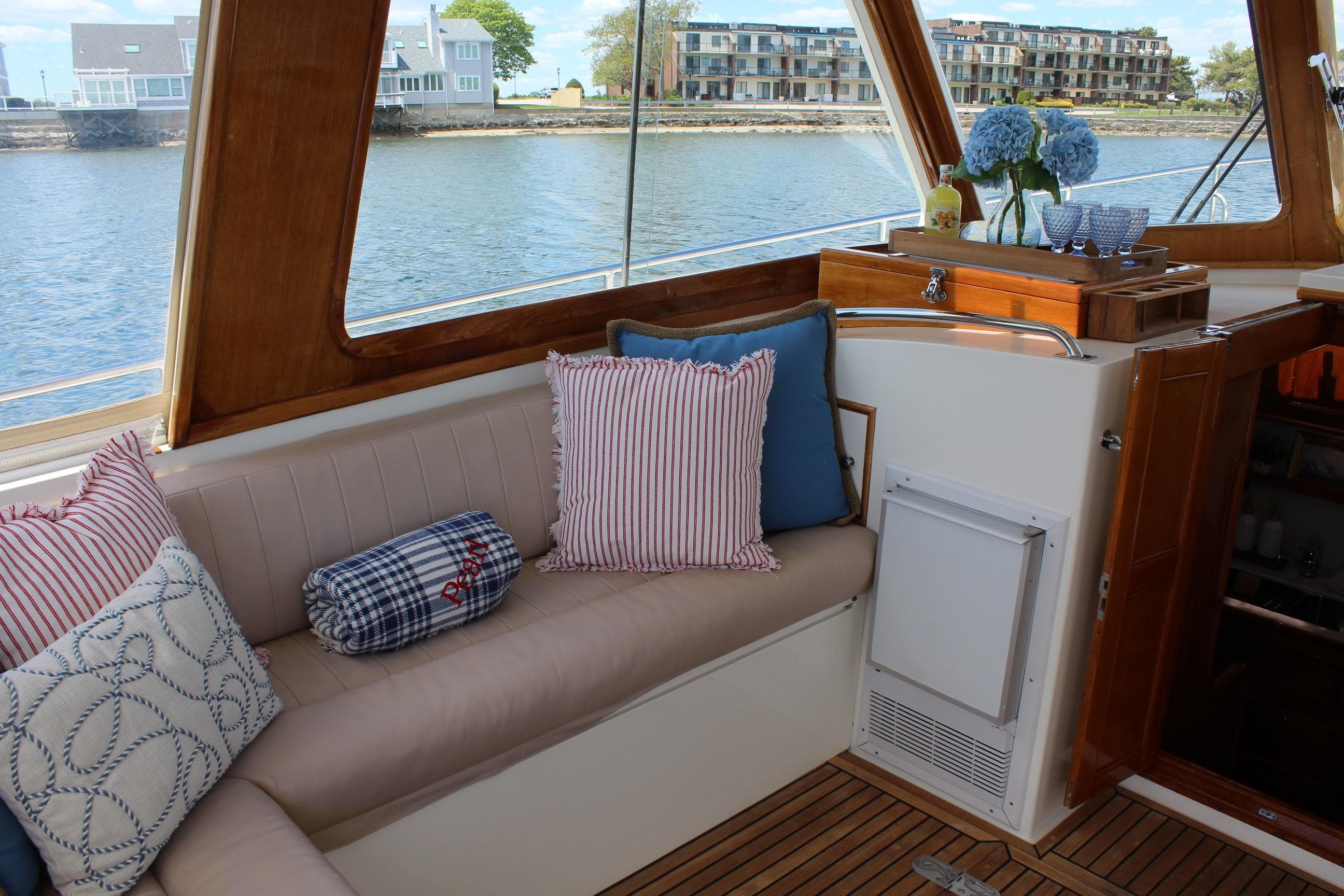 Interior of 1999 Grand Banks 38 Eastbay HX yacht with cozy seating and decorative pillows.