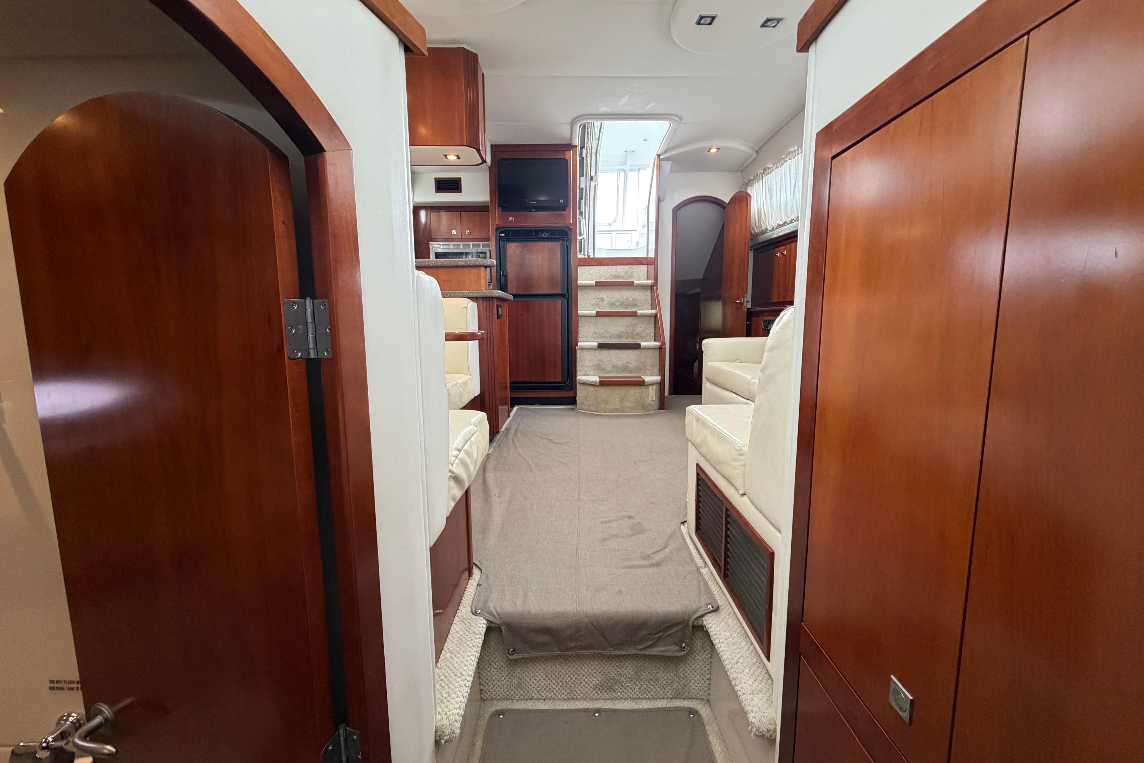 Interior of 2011 Cruisers Yachts 415 Express Motoryacht with wood finishes and seating.
