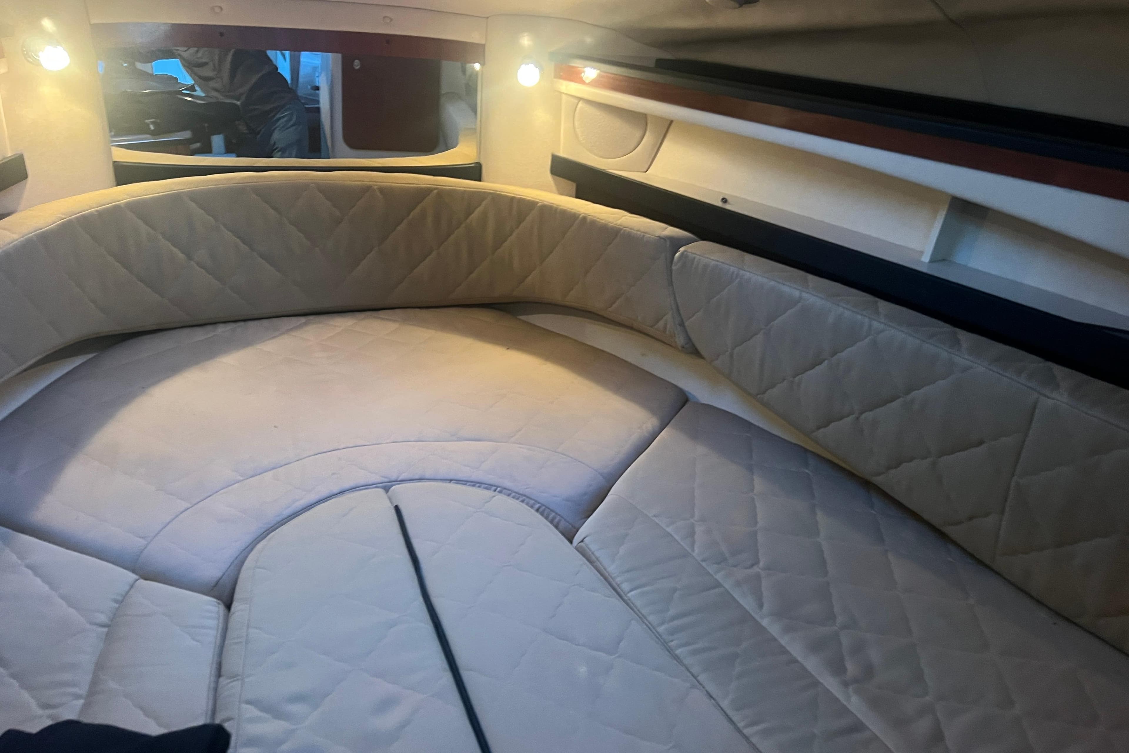 2007 Sea Ray 260 Sundancer cabin interior with cushioned seating and ambient lighting.