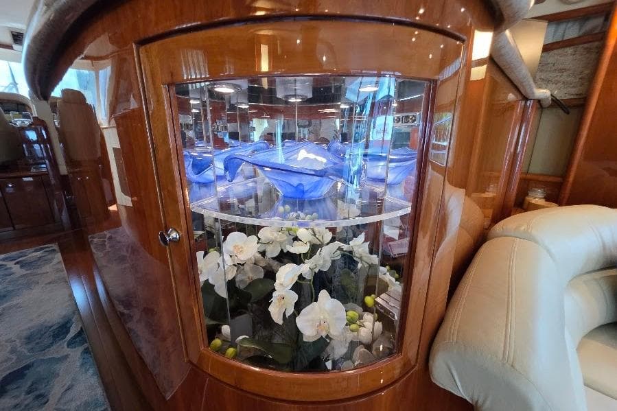 Luxurious interior of 2008 Neptunus Flybridge MY yacht with elegant floral display.