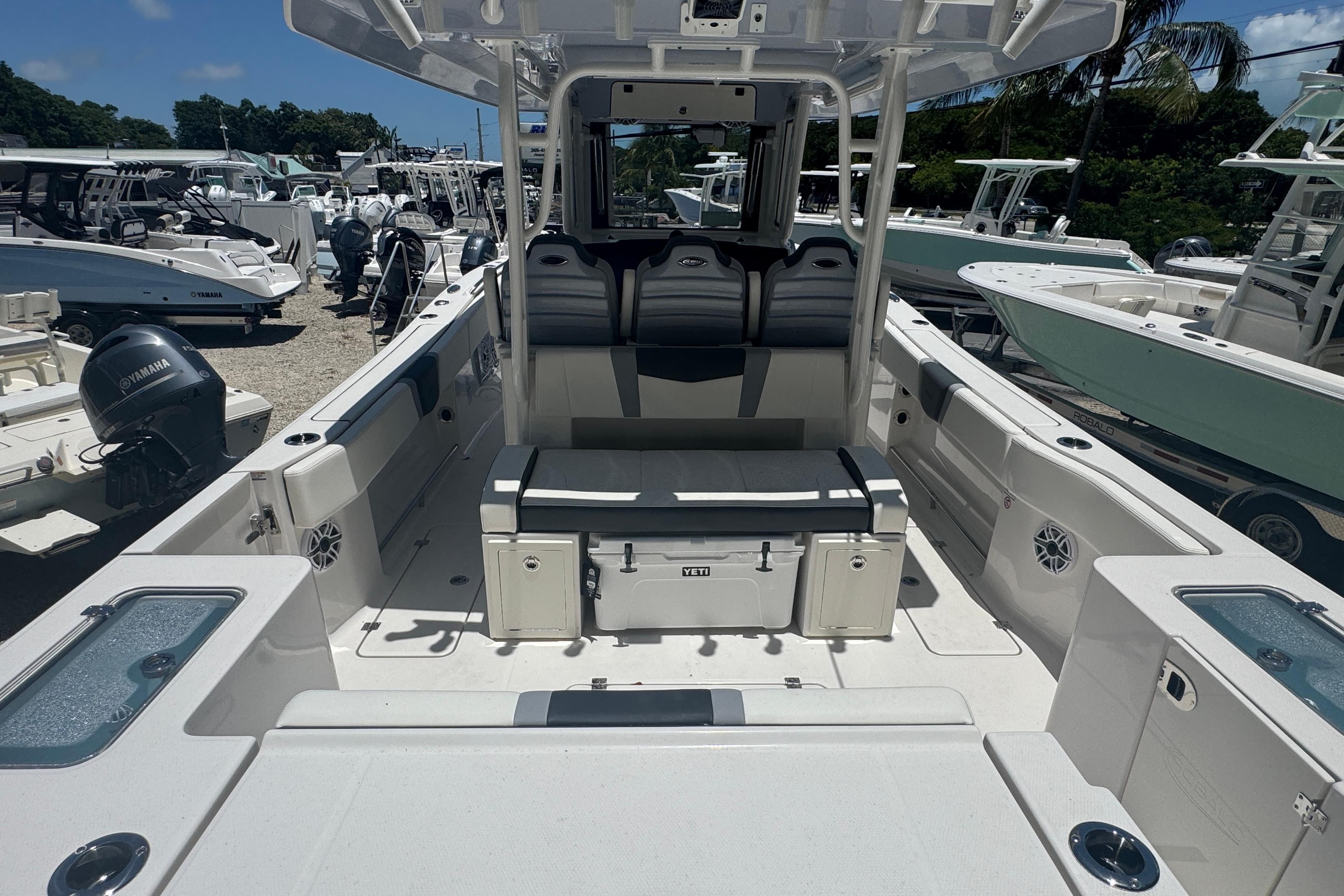 2025 Robalo R300 Center Console boat interior with seating and storage, docked among other boats.
