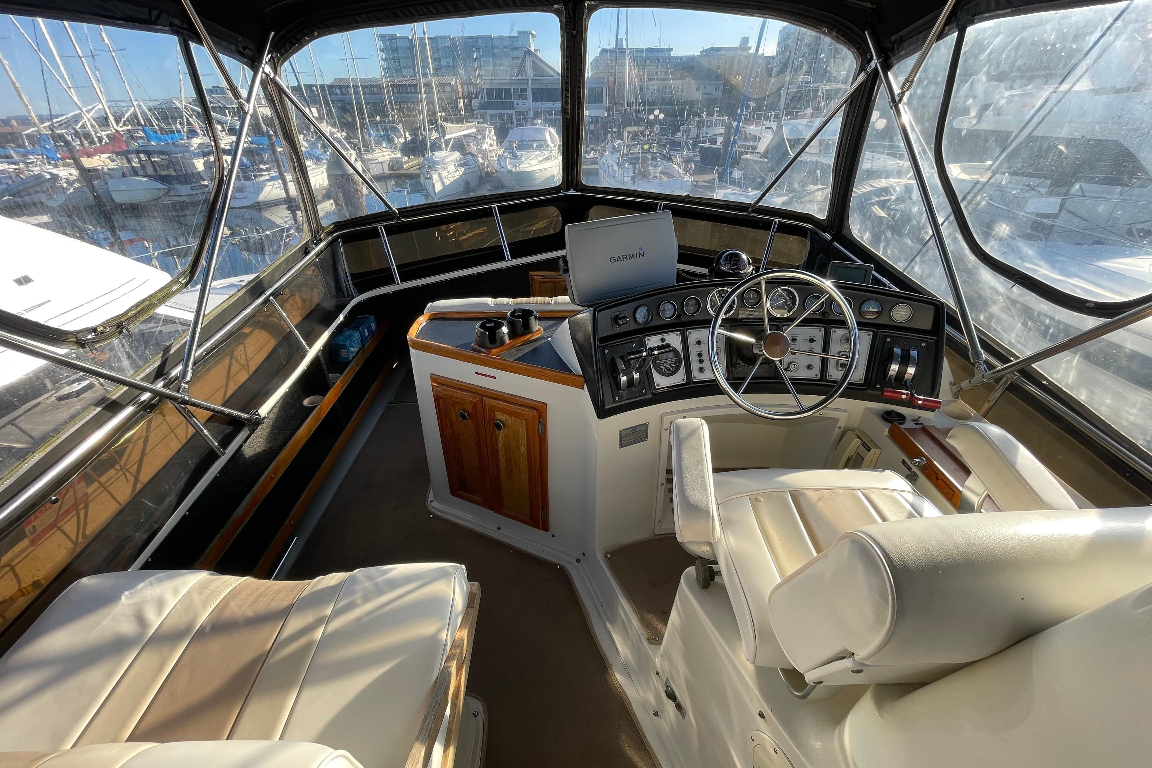 1988 Carver 3607 Aft Cabin Motor Yacht helm with steering wheel and navigation equipment.