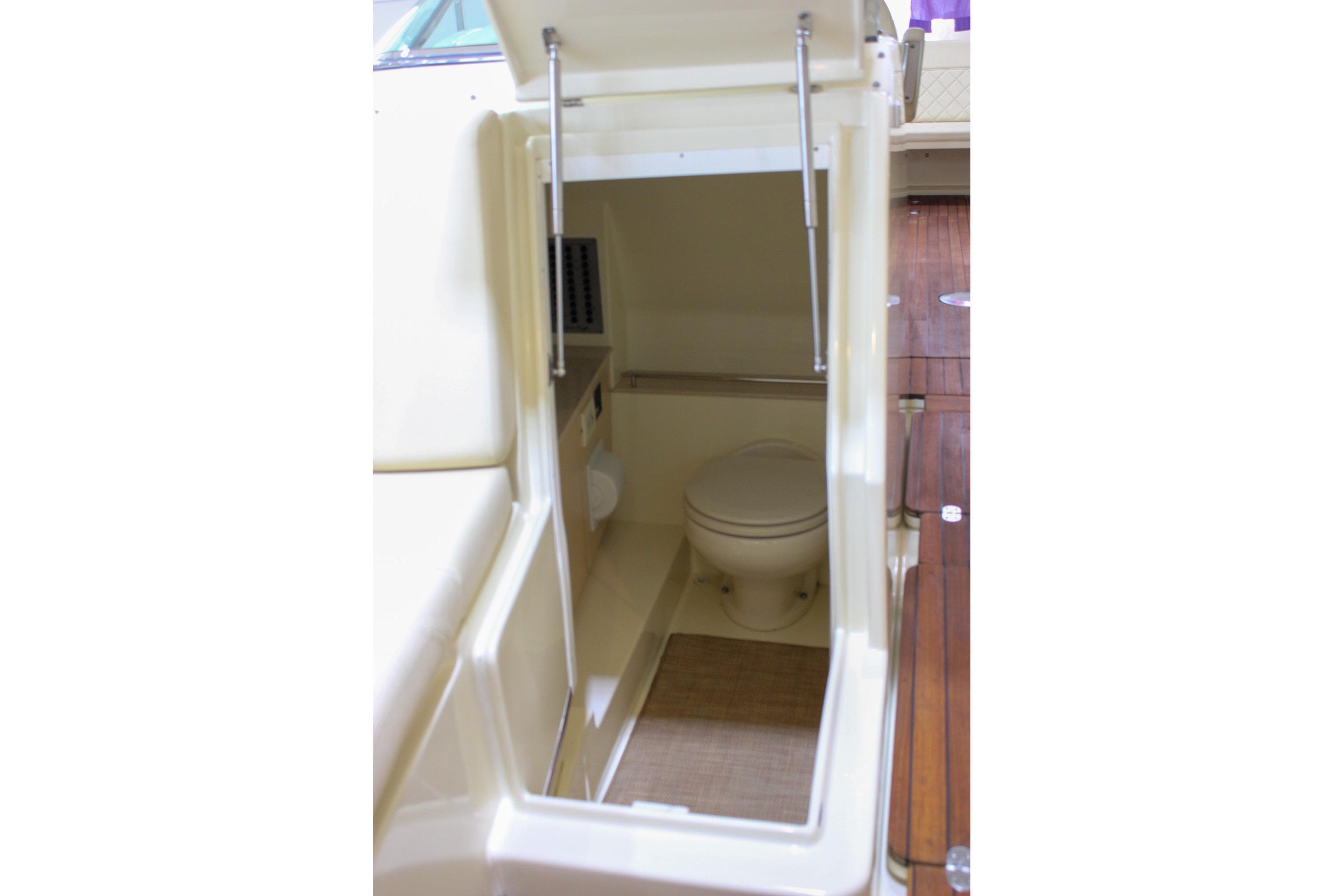 2018 Chris-Craft Calypso 30 boat interior with compact marine toilet.