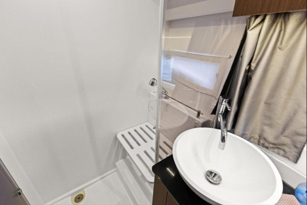 Bathroom interior of 2021 Jeanneau NC 1095 boat with modern sink and shower.