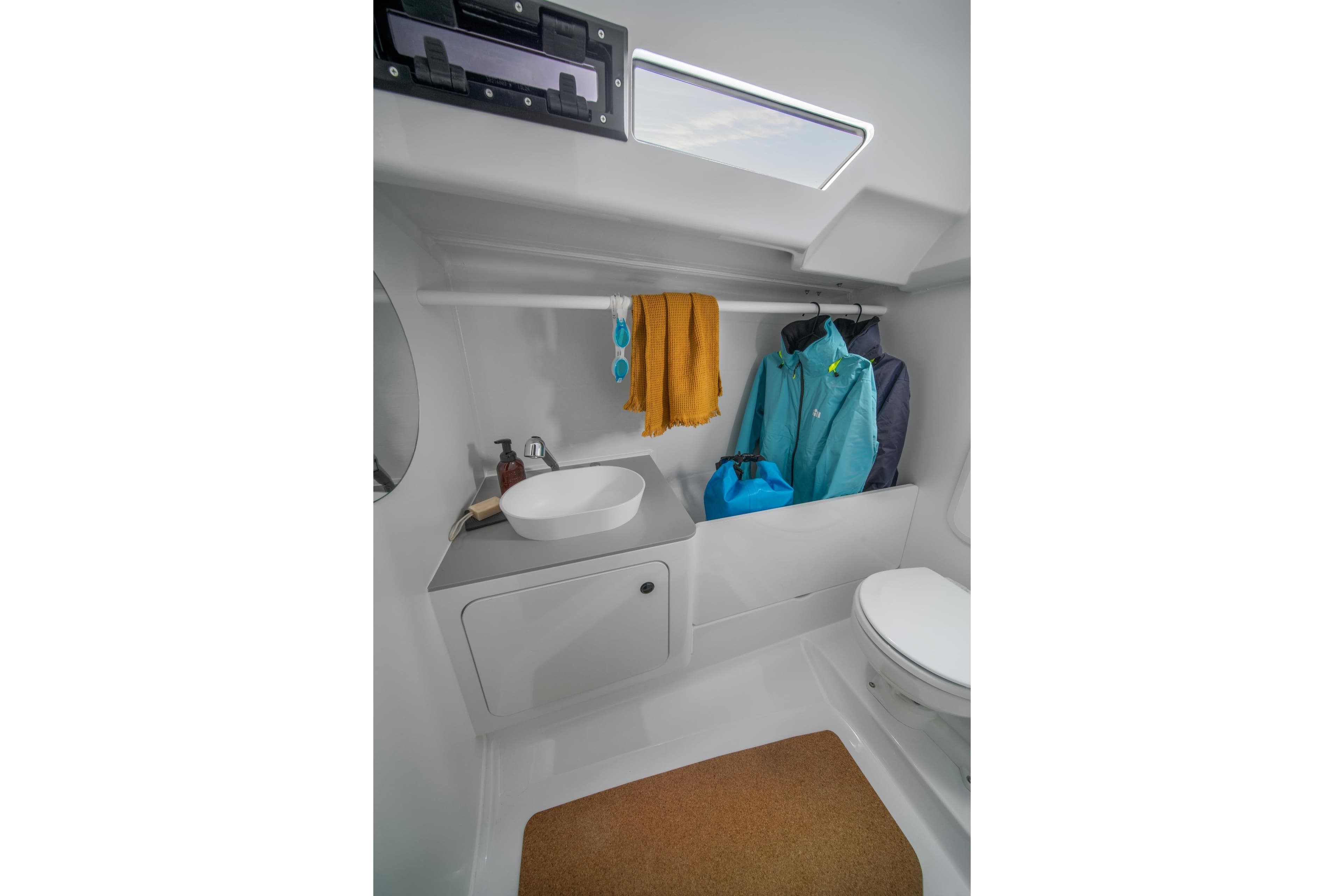 Modern bathroom interior of 2026 Beneteau First 30 yacht with sink and storage.