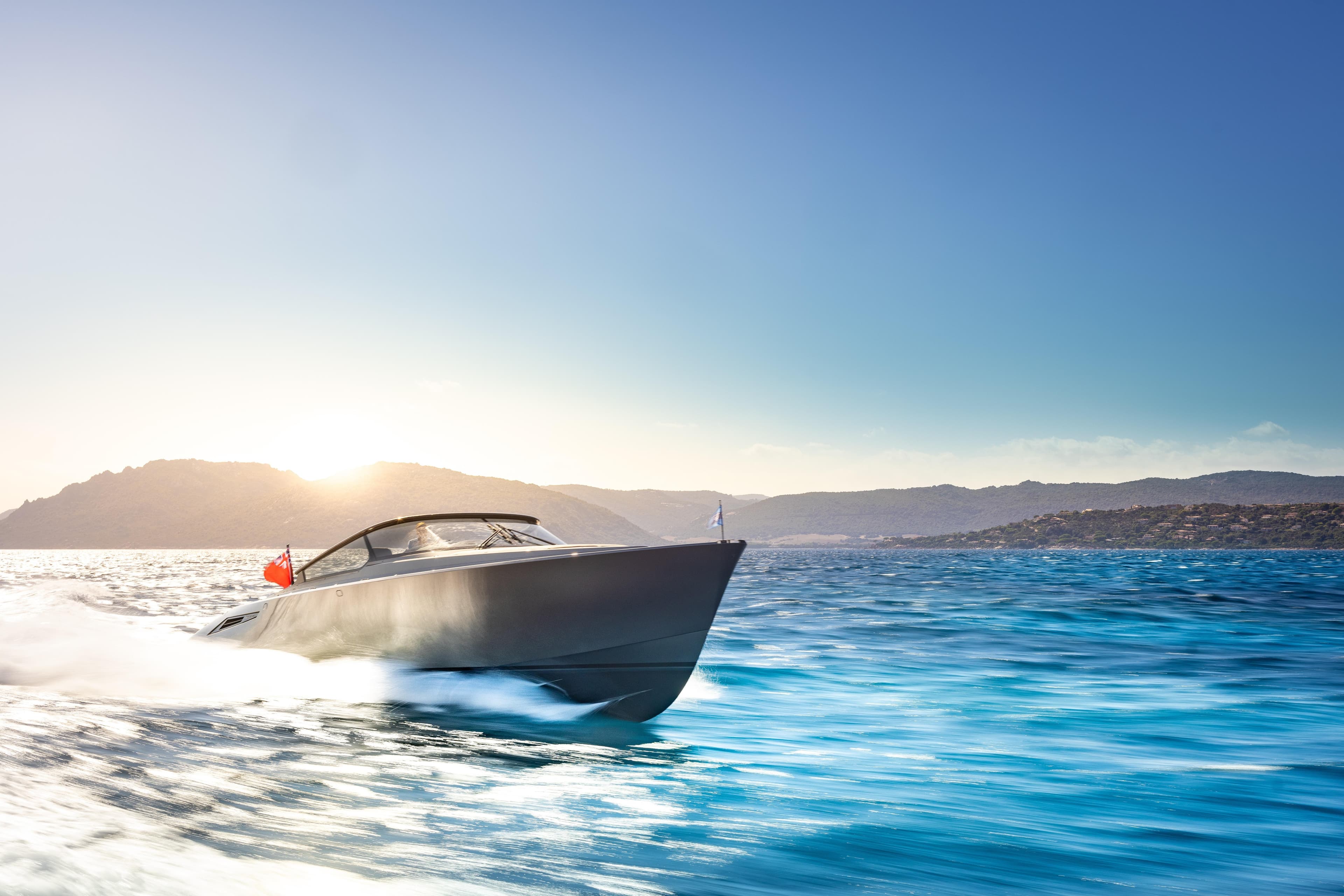 Luxury Wajer 55 yacht cruising on blue waters, 2019 model, with scenic mountain backdrop.