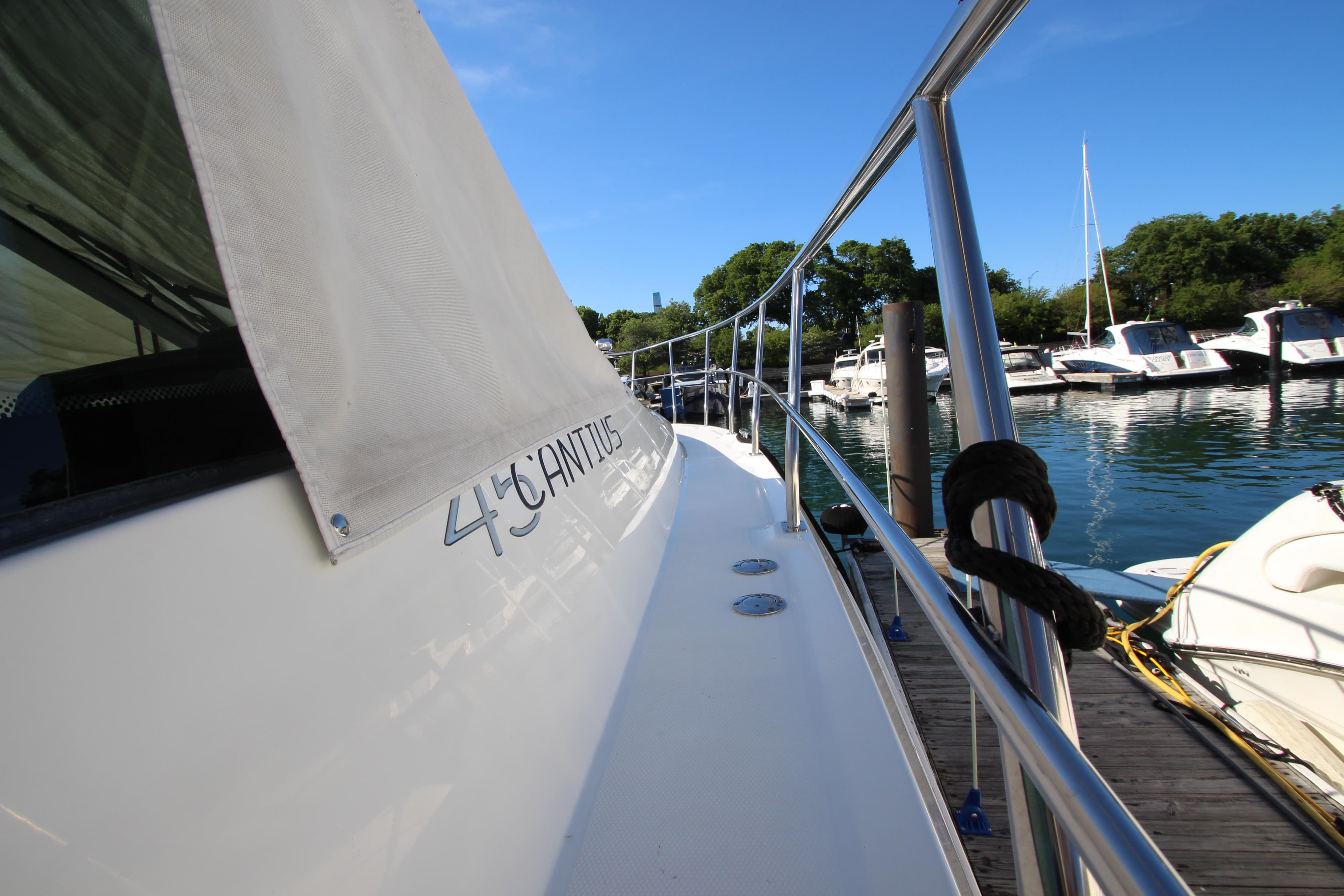 2014 Cruisers Yachts 45 Cantius docked, showcasing sleek design and marina view.