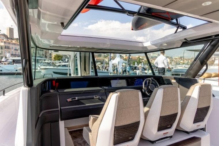 Interior view of 2027 Axopar 45 Cross Top boat with modern seating and dashboard.