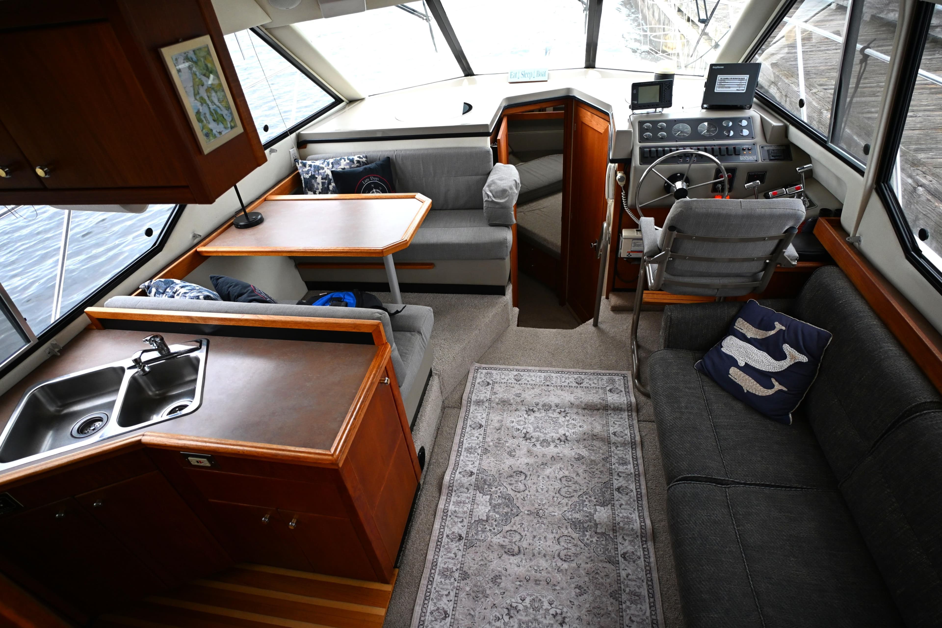 1996 Bayliner 4087 Aft Cabin Motoryacht interior with seating, kitchen, and helm.