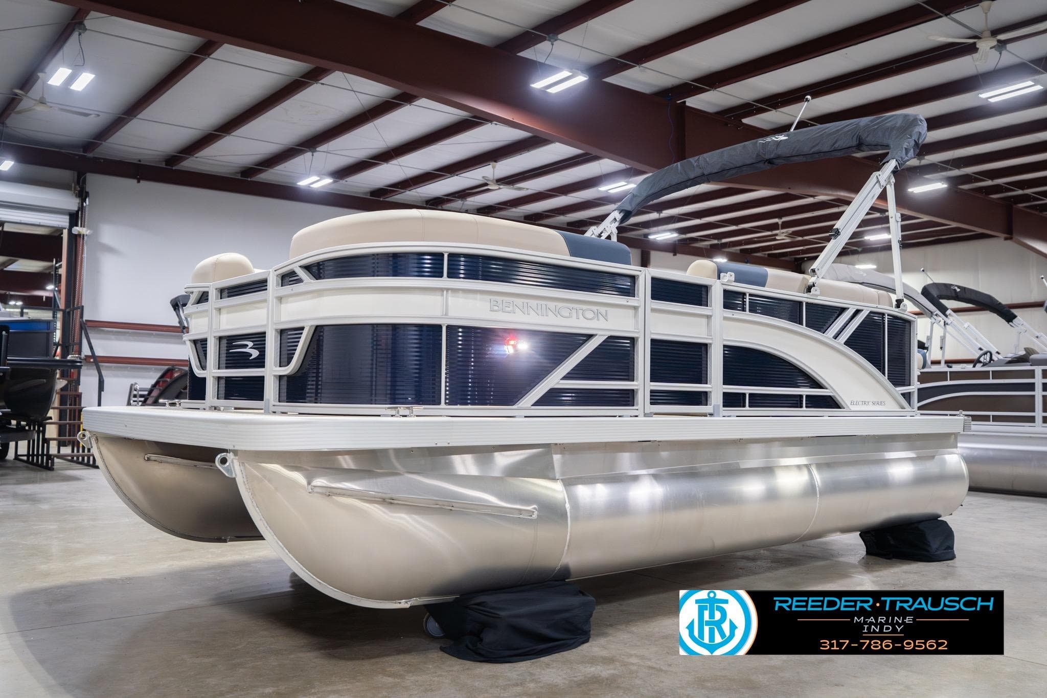 2026 Bennington 168 SLJ pontoon boat in showroom, featuring sleek design and modern amenities.