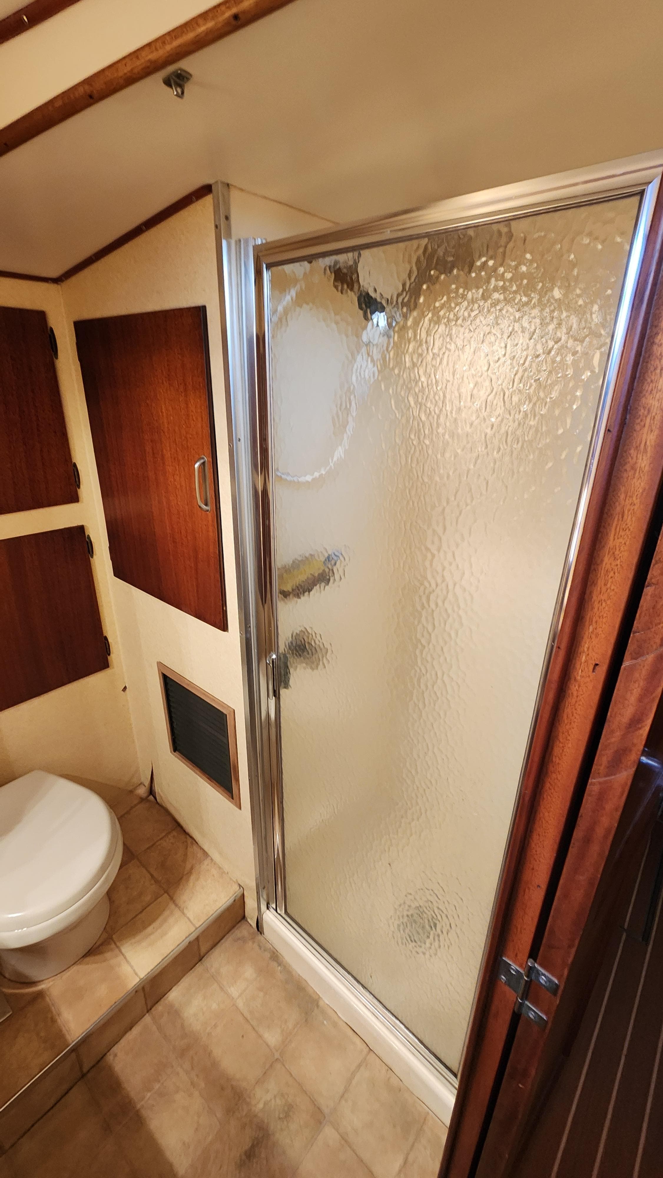 Bathroom interior of 1969 Hatteras 36 Sport Fisherman with shower and toilet.