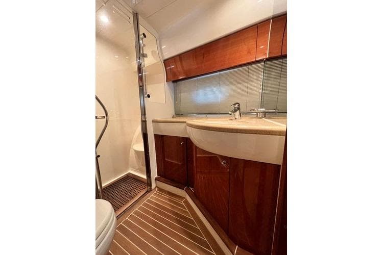 Luxurious bathroom in 2003 Viking Princess 50 Sport Cruiser with wood accents and modern fixtures.