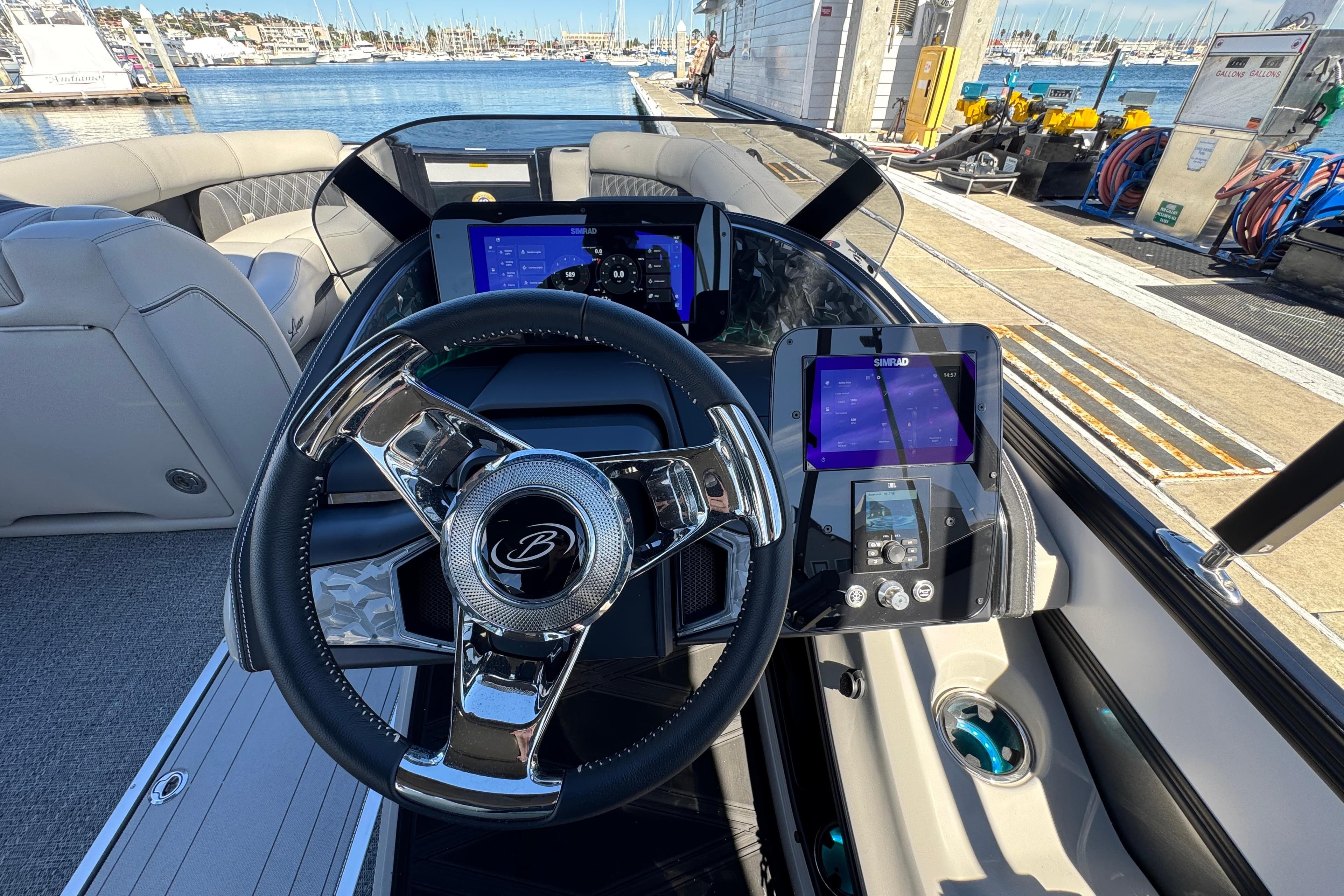 2026 Barletta Lusso 23UC boat dashboard with modern steering and digital displays at marina.
