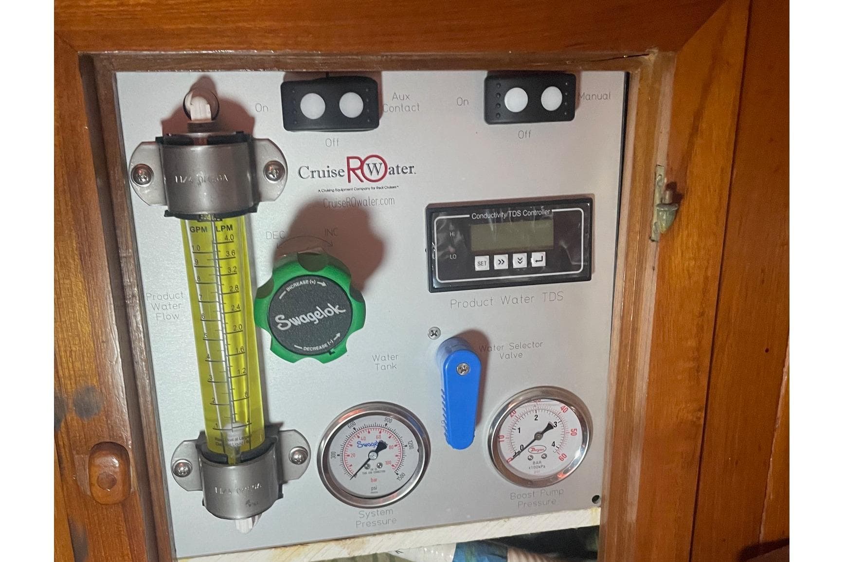 Control panel of a 1980 Hans Christian 43 sailboat with gauges and switches.