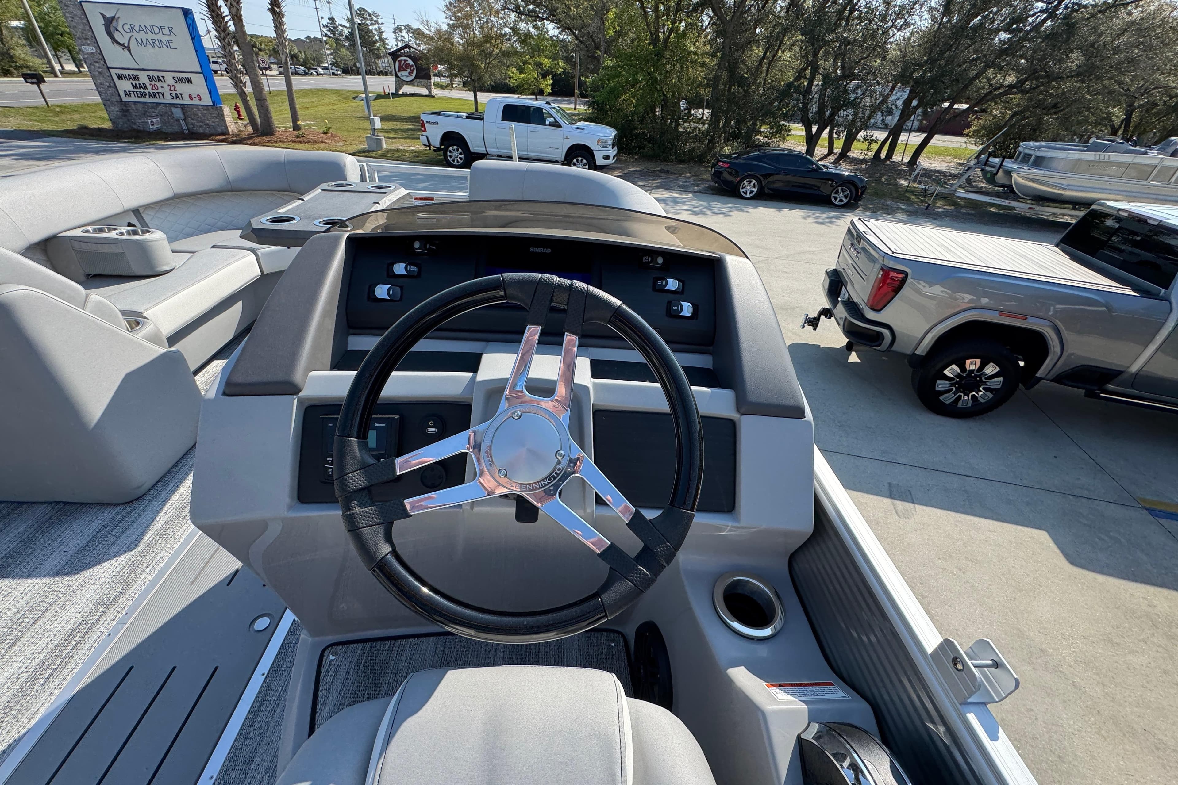 Steering console of 2026 Bennington 22 LFB pontoon boat, featuring modern controls and seating.