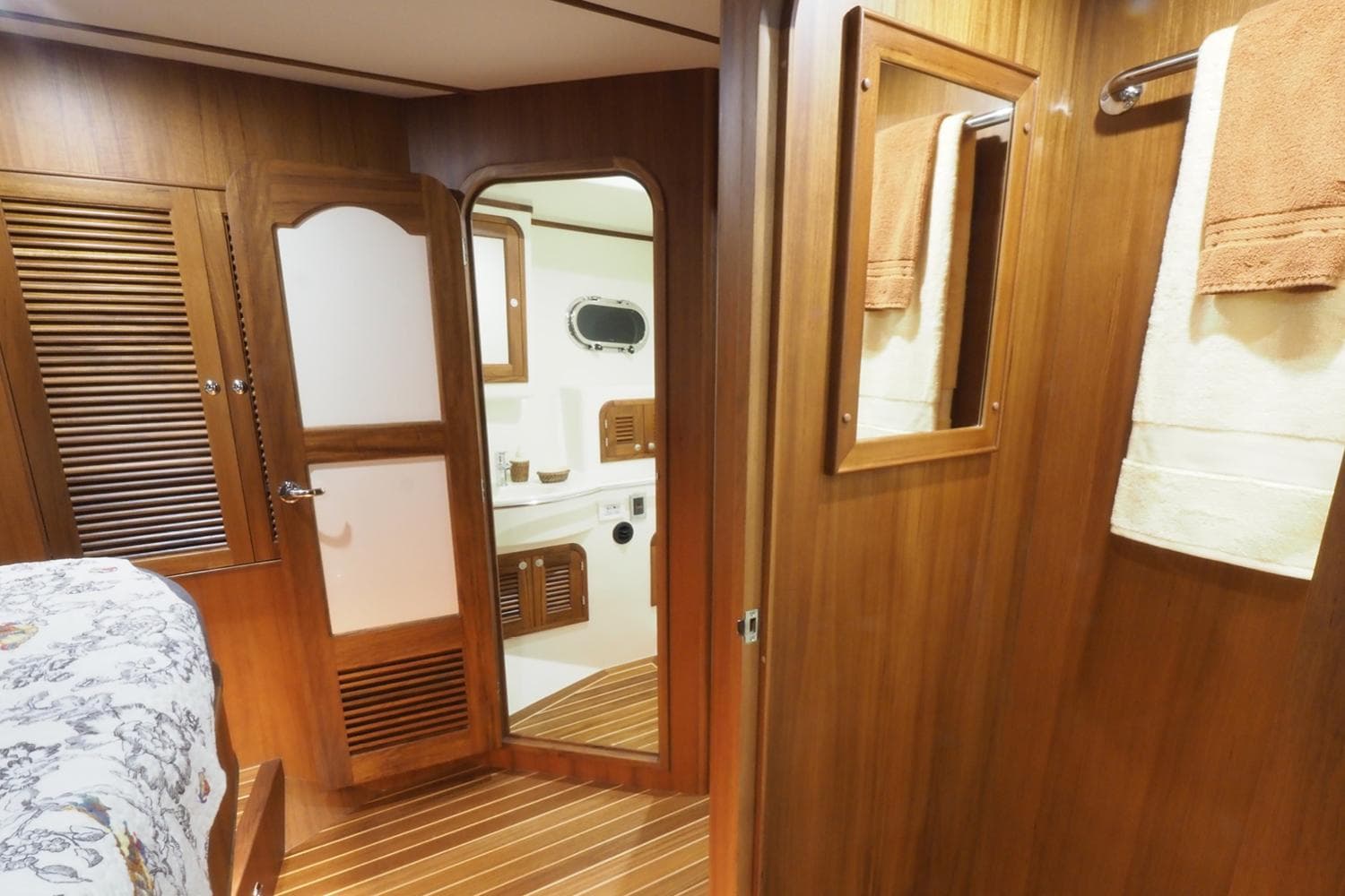 2026 Helmsman Trawlers 46 Pilothouse interior with wood paneling and bathroom view.