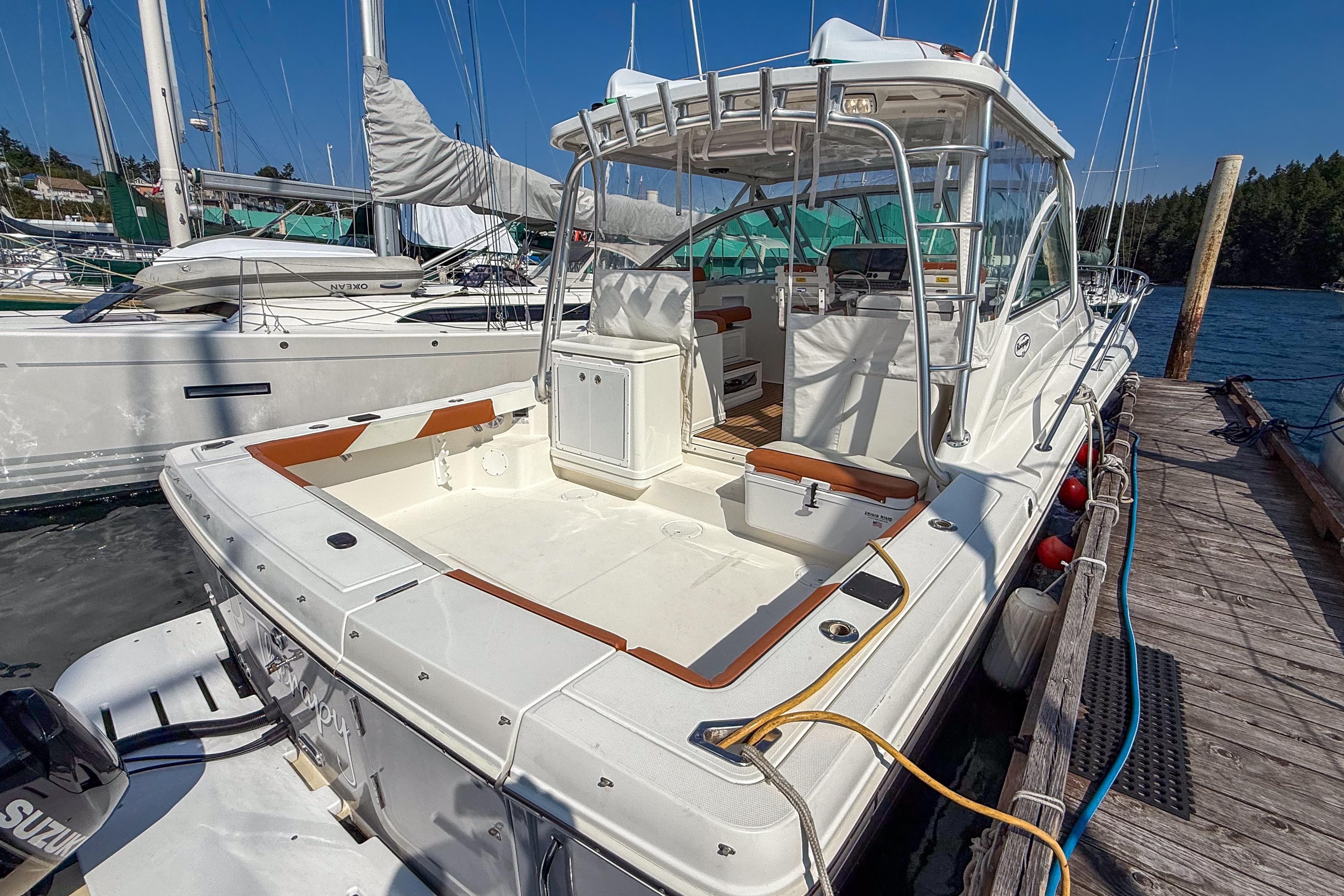 2005 Rampage 33 Express boat docked, showcasing spacious deck and seating area.