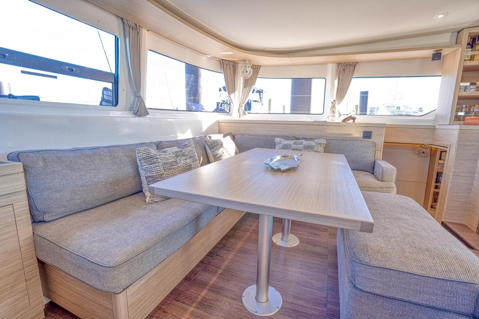 Luxurious interior of 2024 Lagoon 46 yacht with spacious seating and elegant decor.