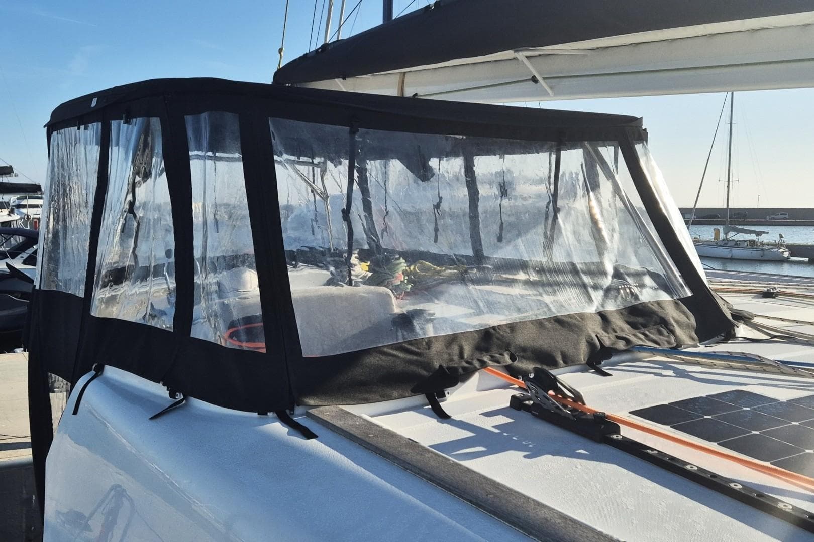 2023 Catana Ocean Class yacht with protective cockpit enclosure in marina.