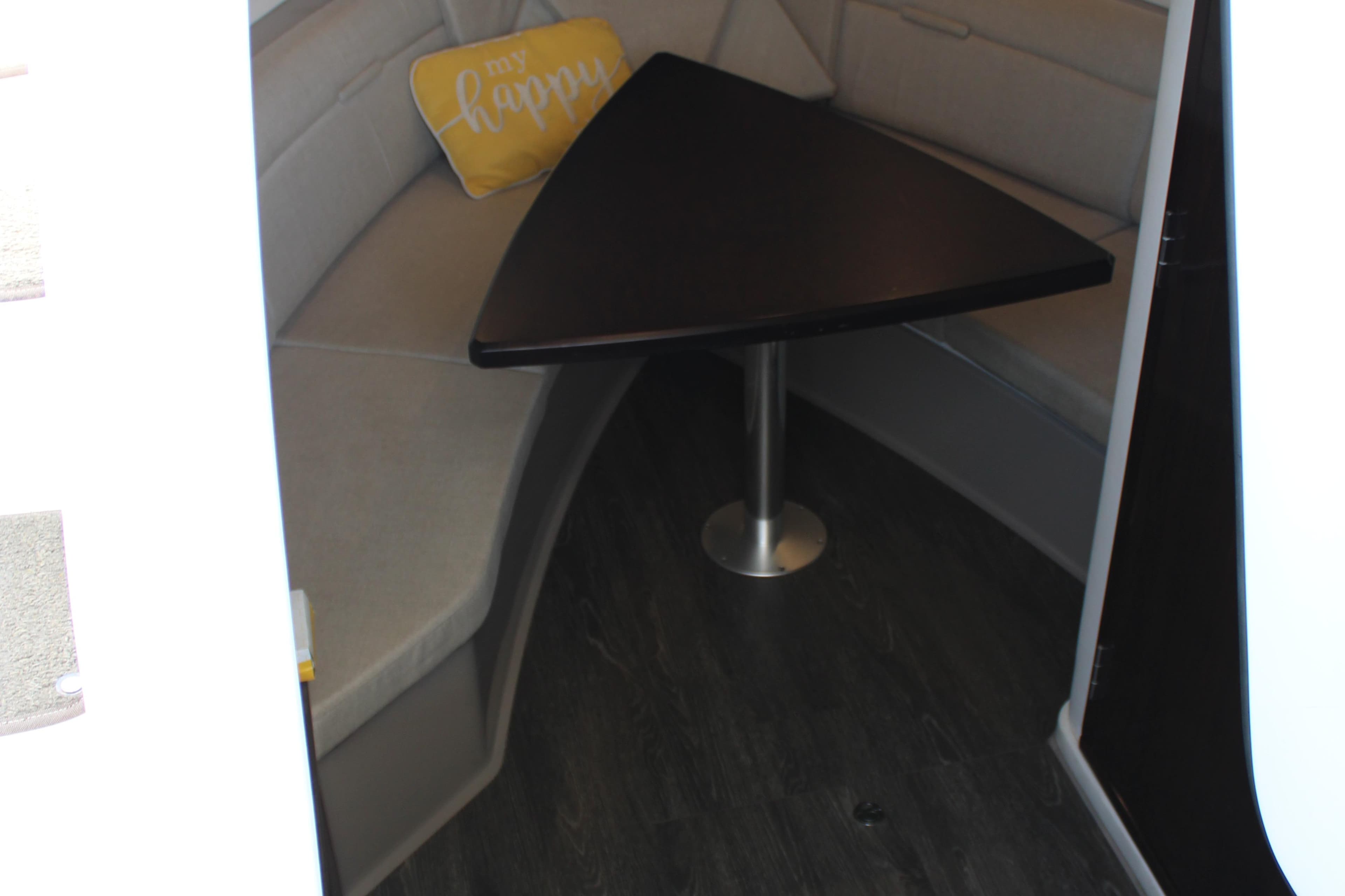 2019 Sea Ray Sundancer 320 interior with triangular table and "be happy" pillow.