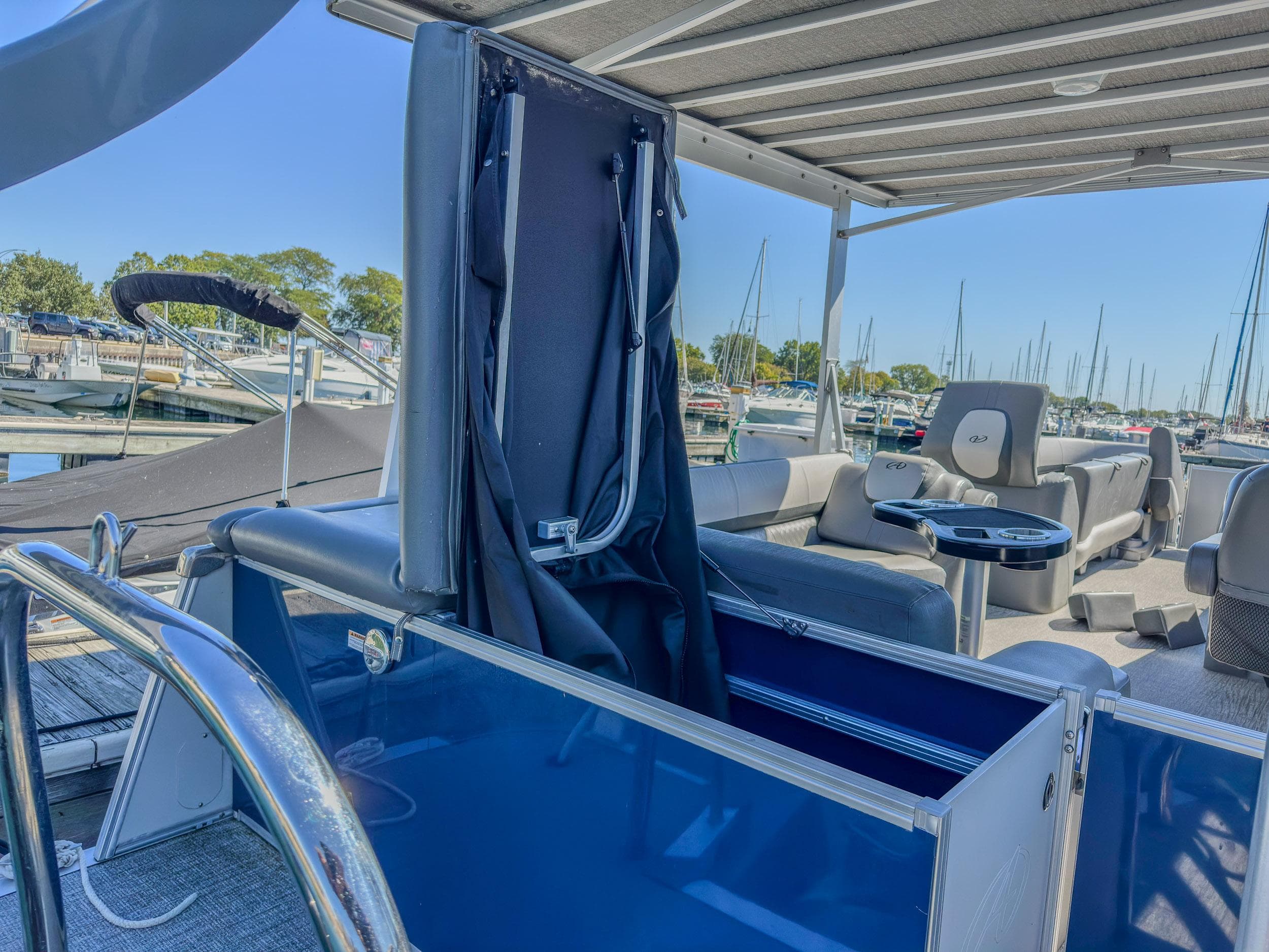 2022 Avalon Catalina FunShip interior with seating and helm, docked at marina.