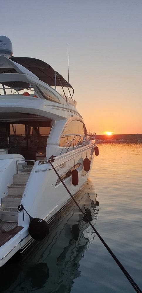 Luxury Princess F62 yacht at sunset, 2020 model, on calm waters.