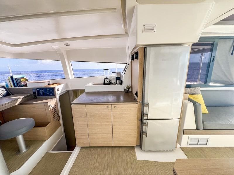 Modern interior of 2016 Bali 4.0 catamaran with kitchen and ocean view.