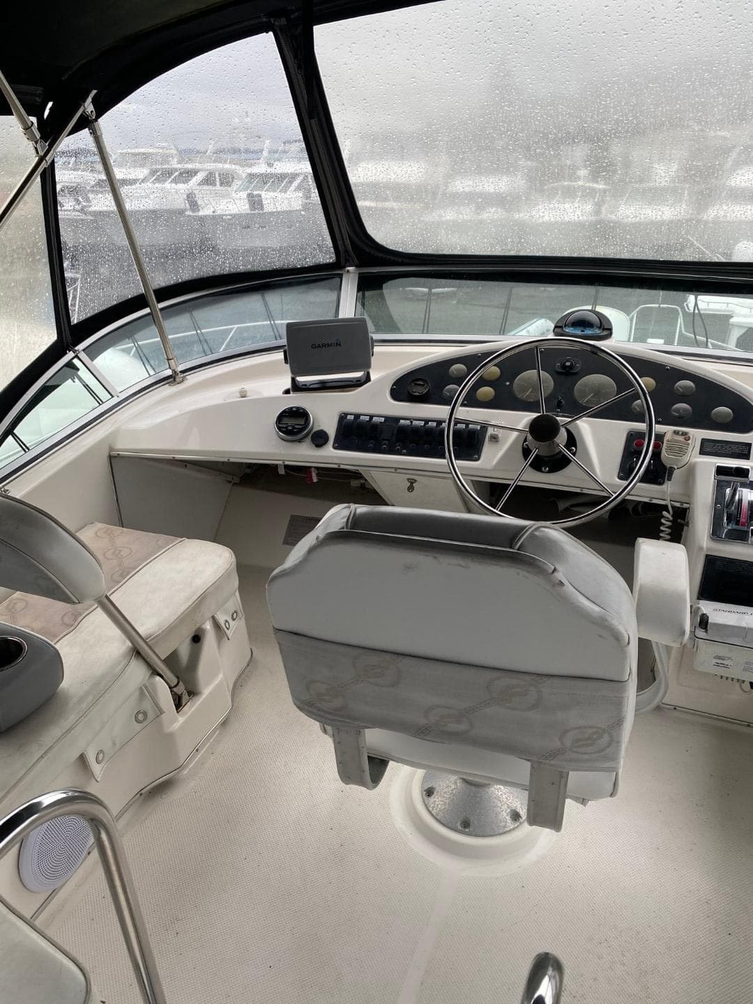 1996 Bayliner 3388 Command Bridge Motoryacht helm with steering wheel and navigation controls.