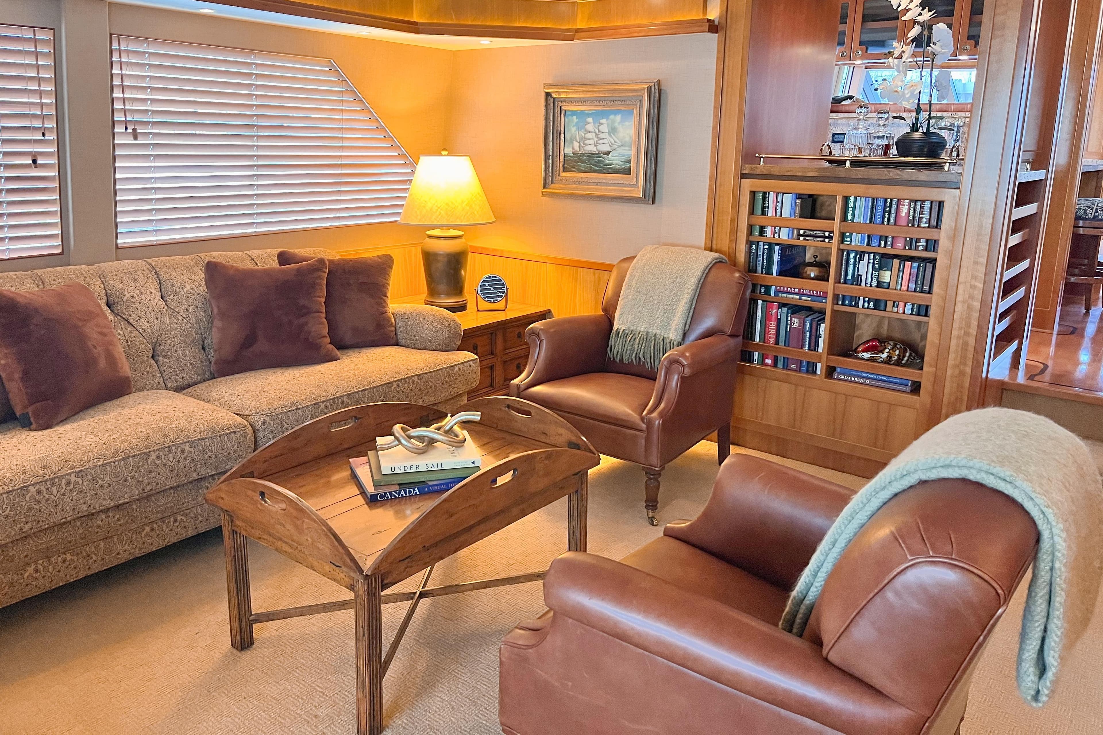 Luxurious 2003 West Bay Sonship yacht interior with cozy seating and elegant decor.