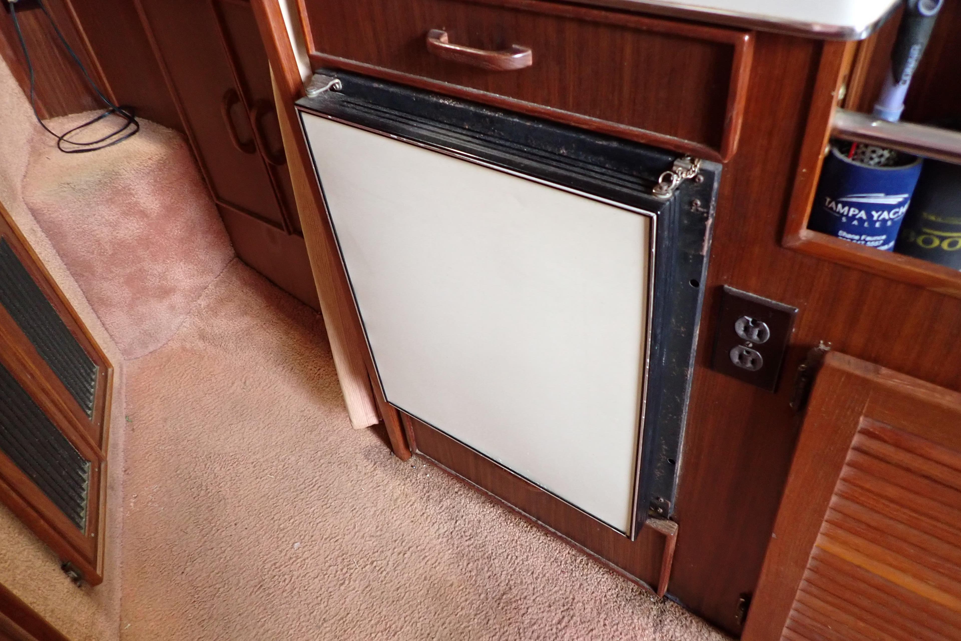 1987 Sea Ray 300 Weekender interior with built-in refrigerator and wood cabinetry.